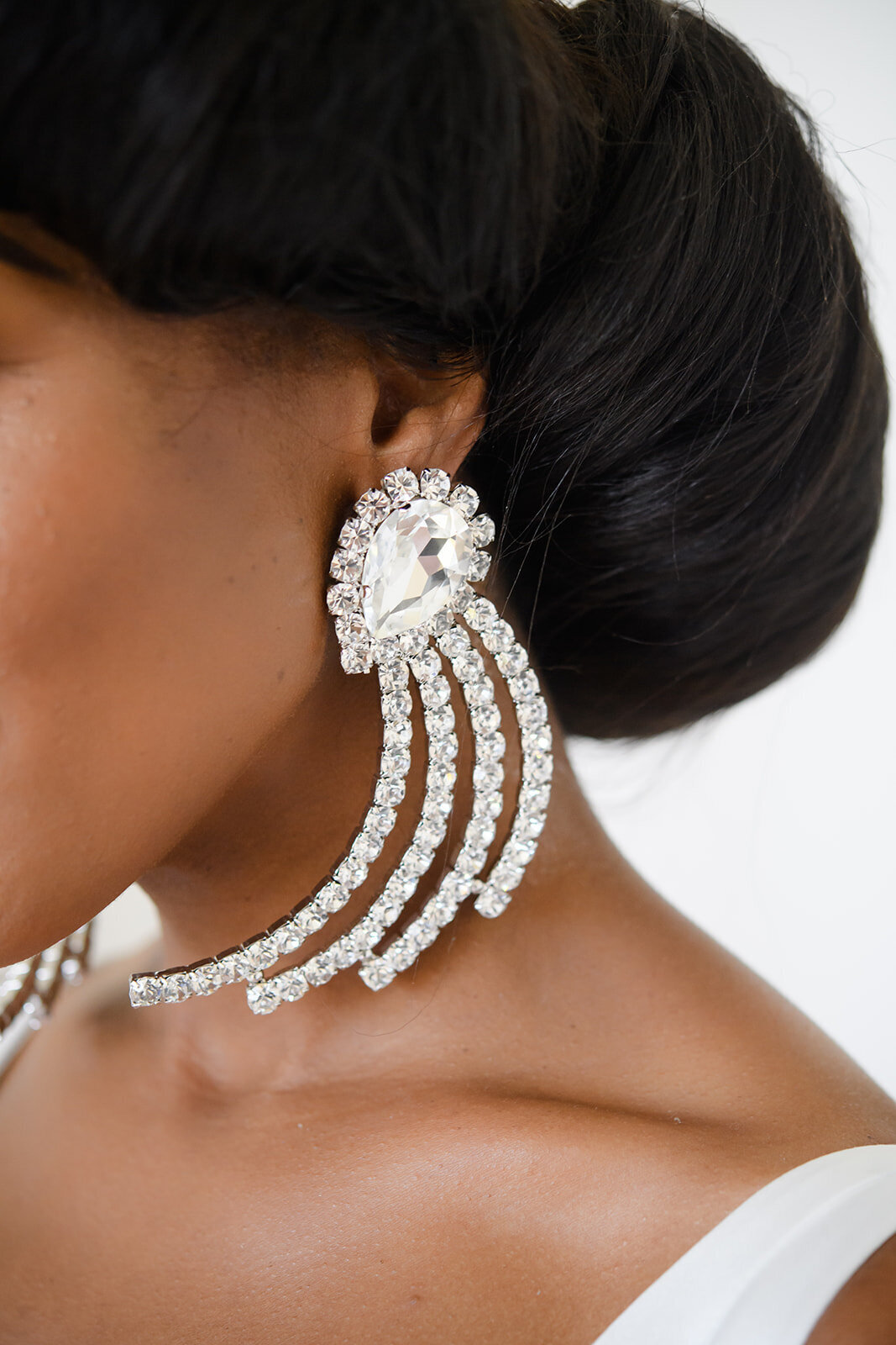 Detailed view of the bride's ornate earrings.