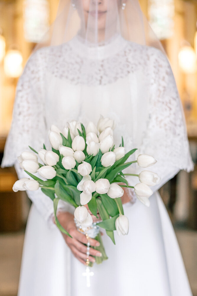 Atlanta Wedding Photographers | Long Sleeve Lace Wedding Gown With White Tulip Bouquet At Traditional Catholic Wedding