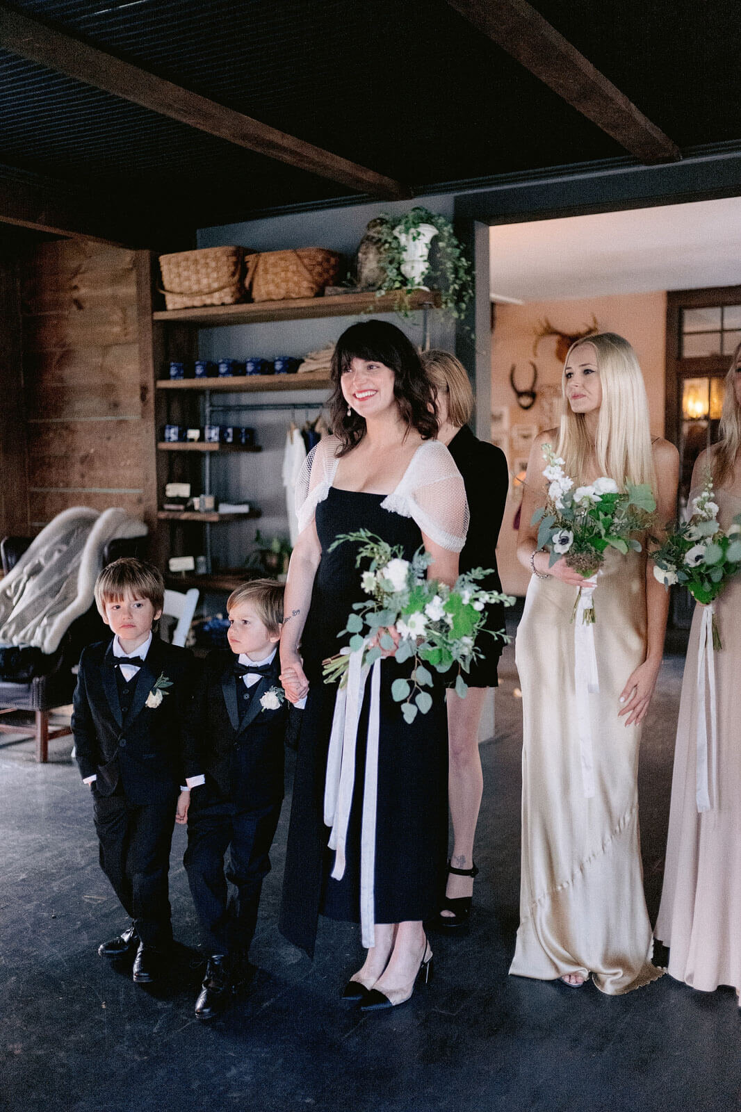 The bridesmaids hold their bouquet with two little boys in Foxfire Mountain House, New York. Wedding Image by Jenny Fu Studio