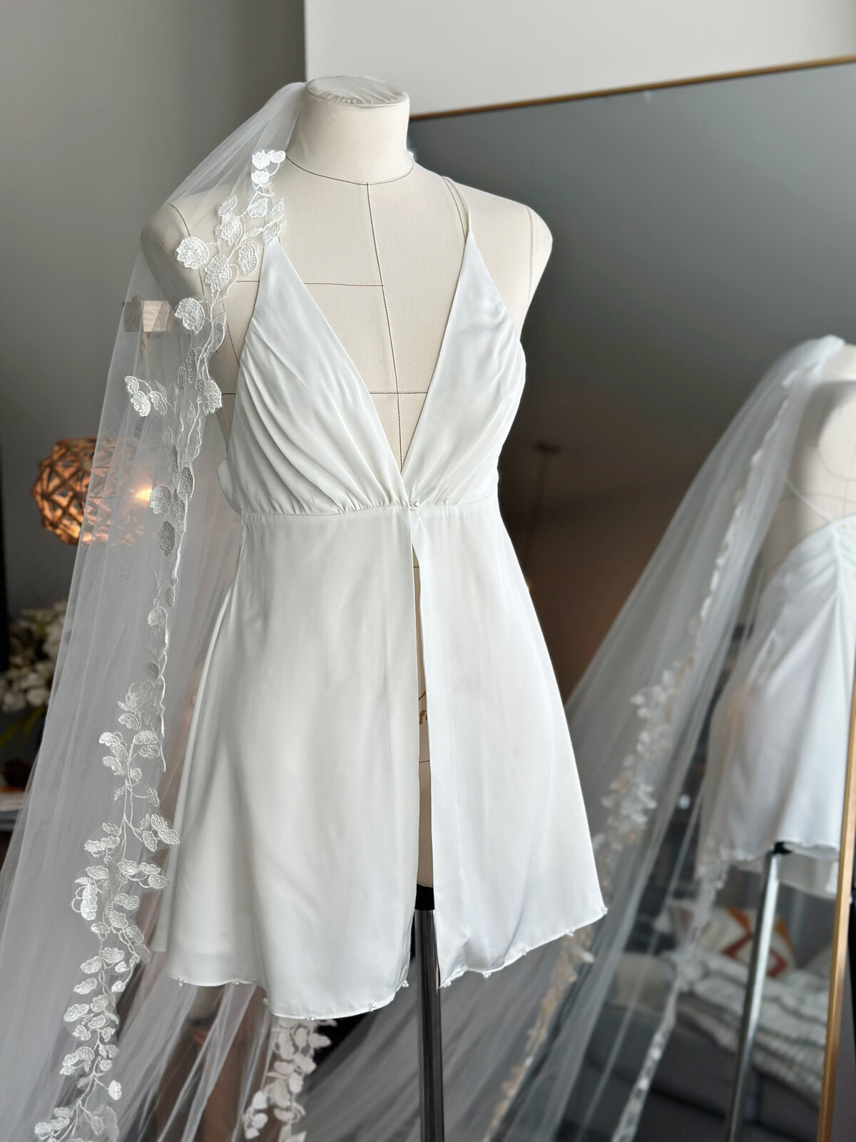 Romantic bridal slip dress featuring delicate hand-beaded neckline and smooth satin flow