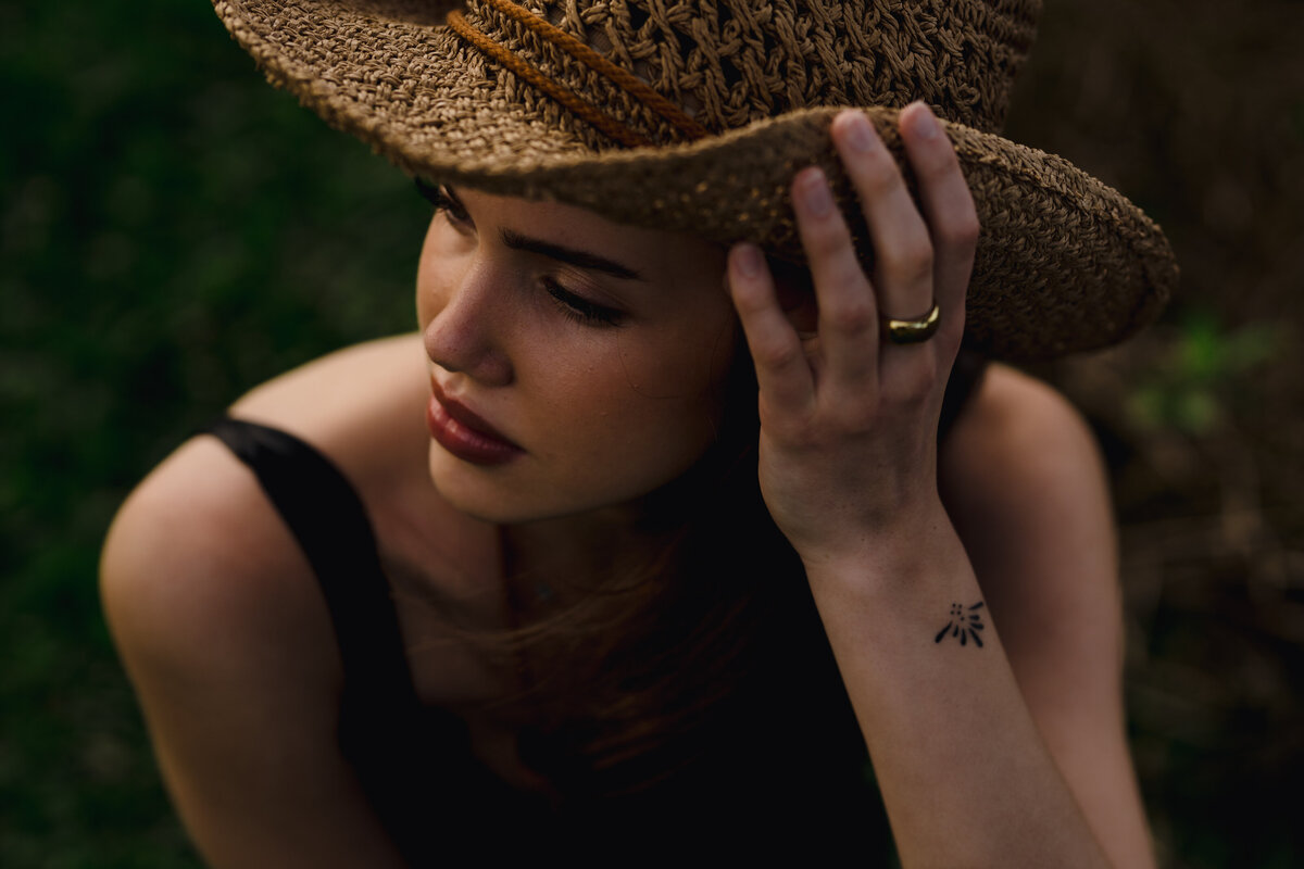 woman in cowboy hat with very moody lighting