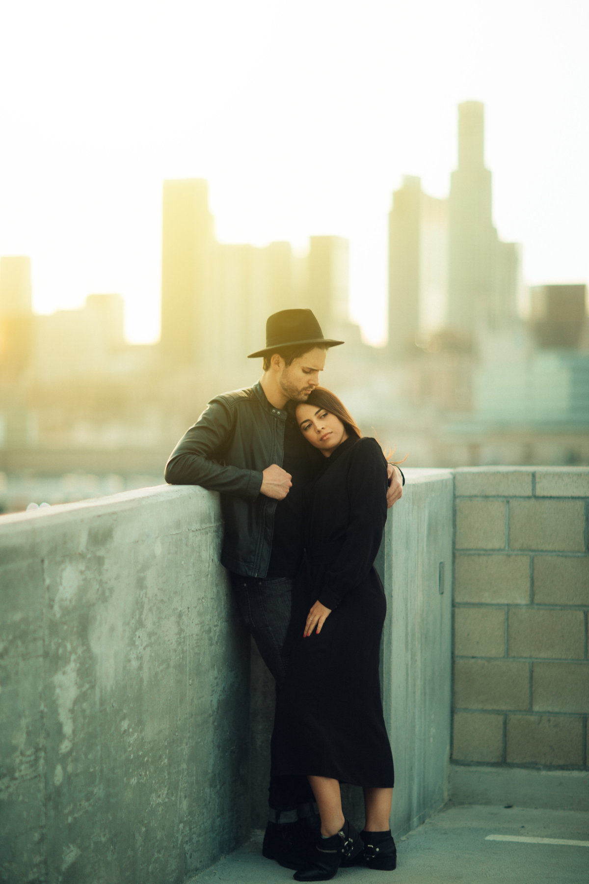 Couple Holding Each Other On Top Of Building