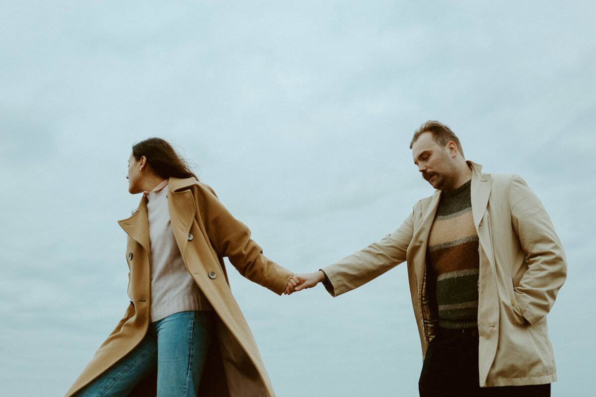 Couple walking hand in hand at fall in Lauttasaari in Helsinki