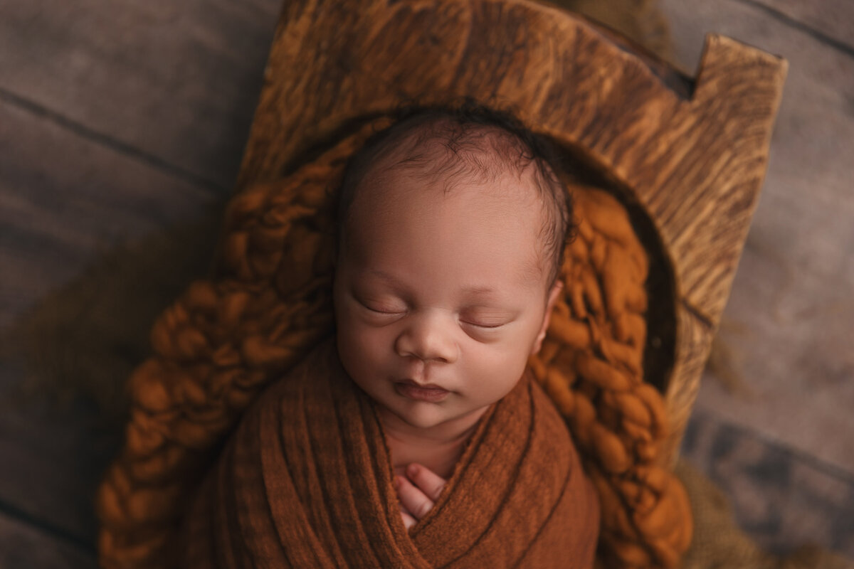 phoenix newborn session baby in orange wrap