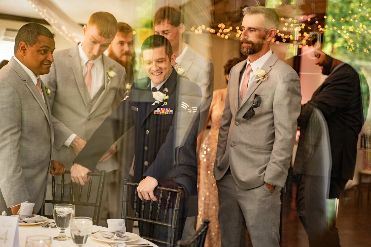 The groom, Beau Atchley, waits in anticipation surrounded by his groomsmen as he waits for the ceremony to start at his wedding at Cheers Chalet in Lancaster, Ohio.