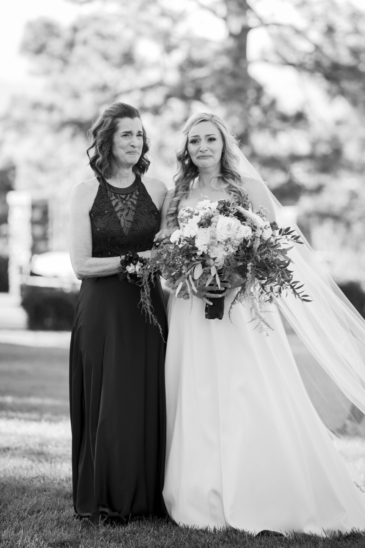 A candid moment with a bride and her mother as they walk up the aisle during the wedding ceremony.