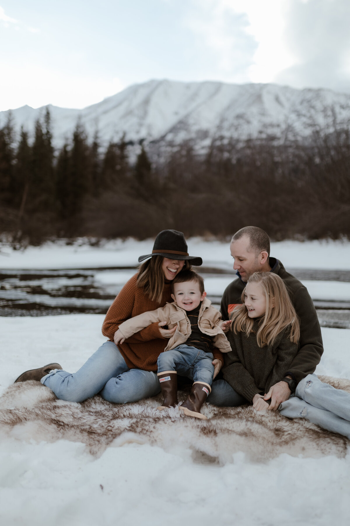 family posing in snow