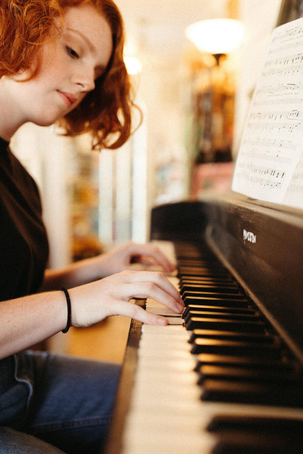 High school senior playing piano in a bookstore