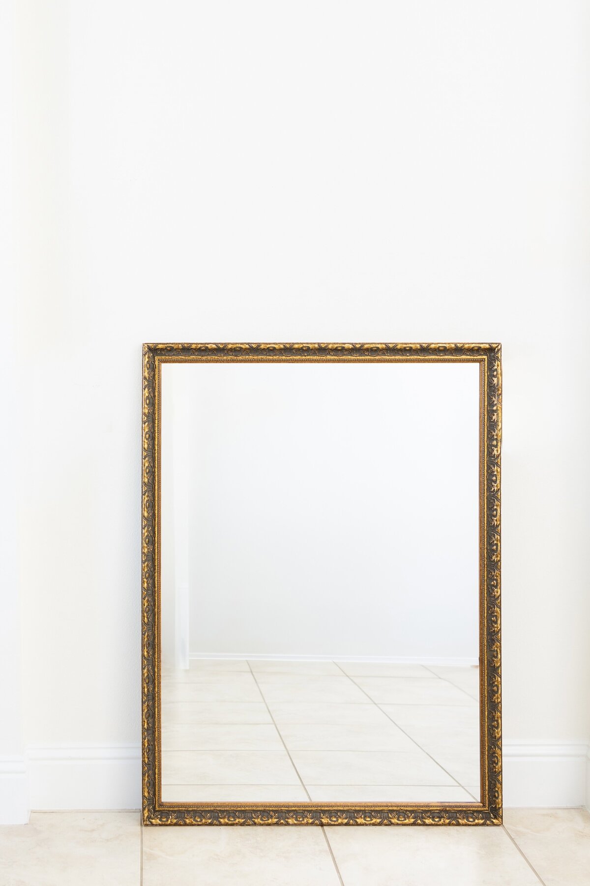 Large gold mirror with ornate border 