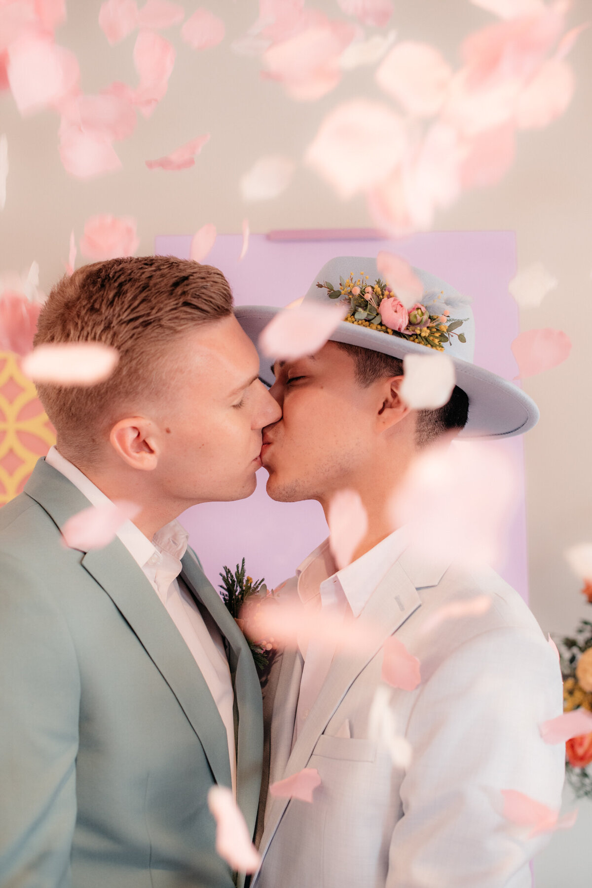 two grooms kissing at the altar