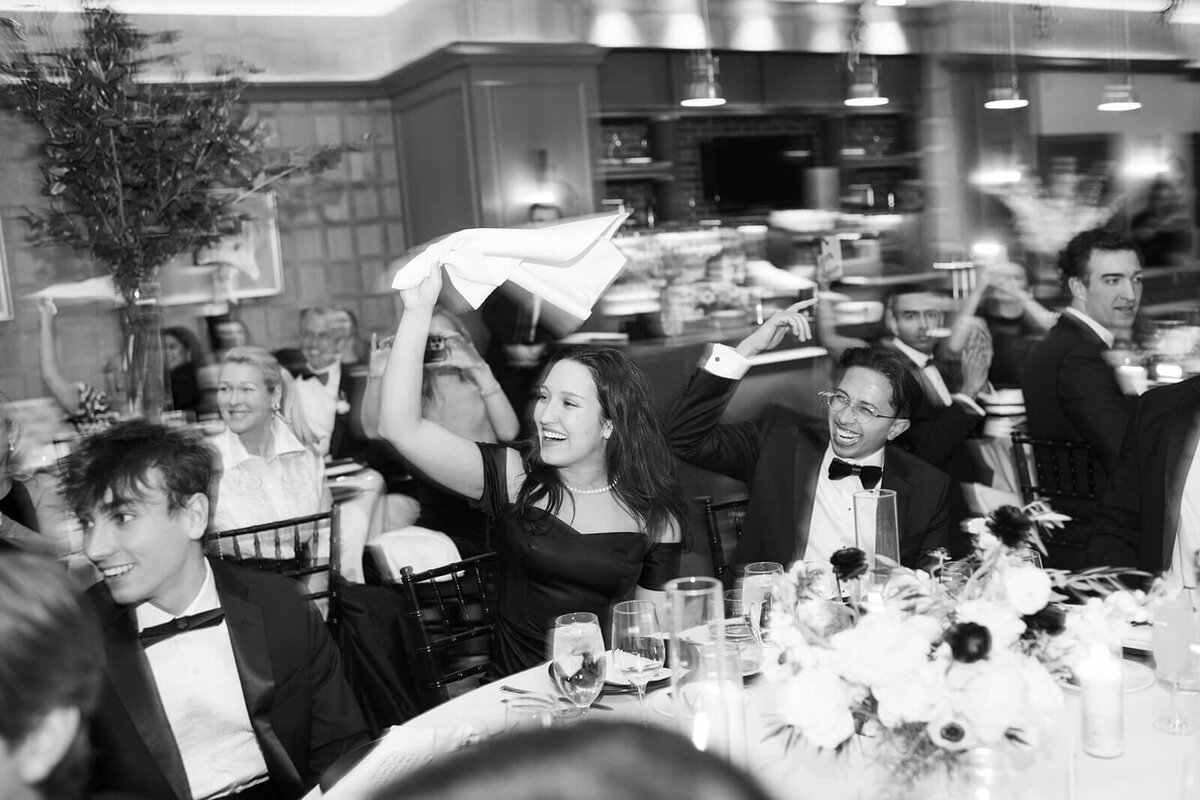 Guests cheer joyfully for the bride and groom at the St. Regis Aspen wedding reception.