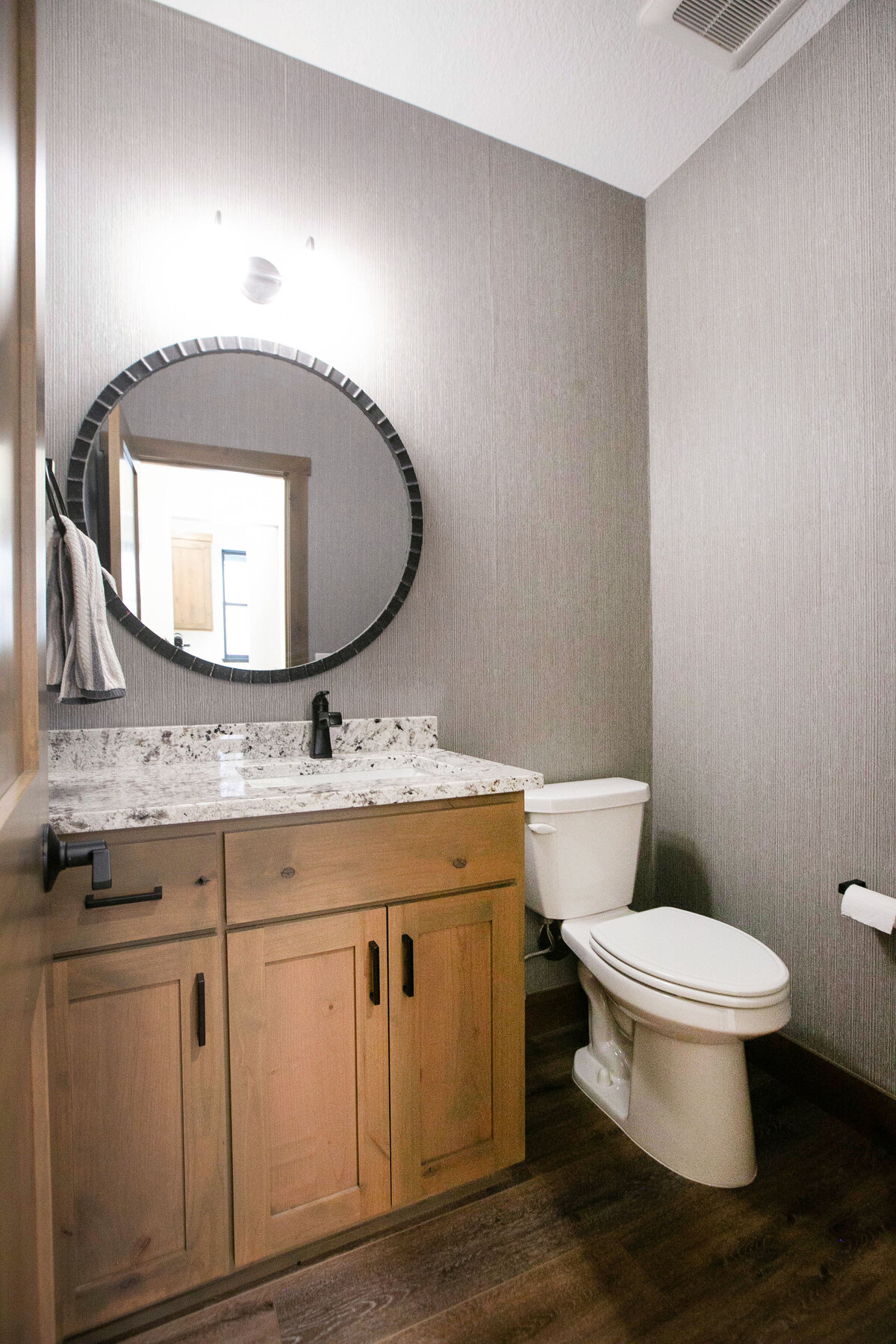 Custom bathroom with with dark cabinets and modern finishes in Elk River Custom Home.