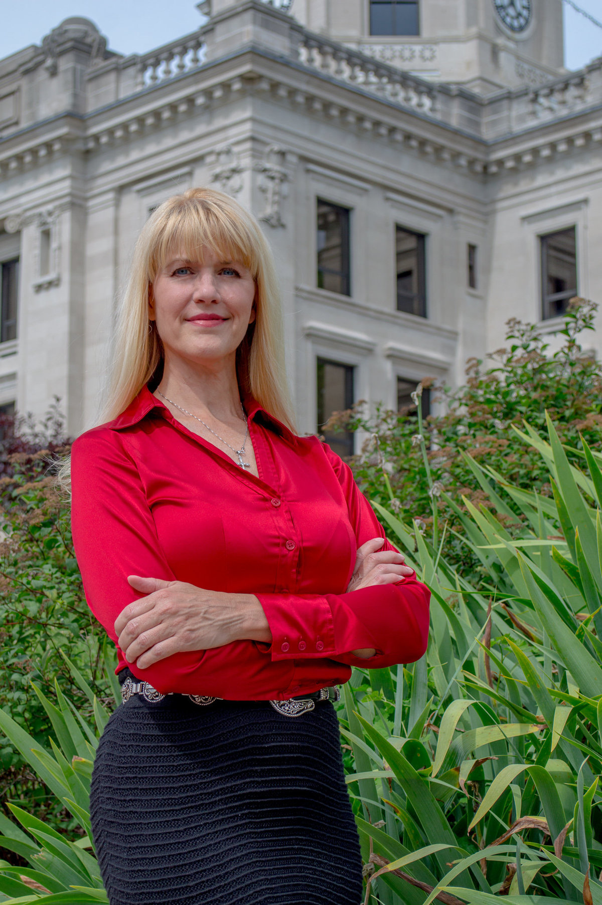 A lawyer poses in front of the courthouse.