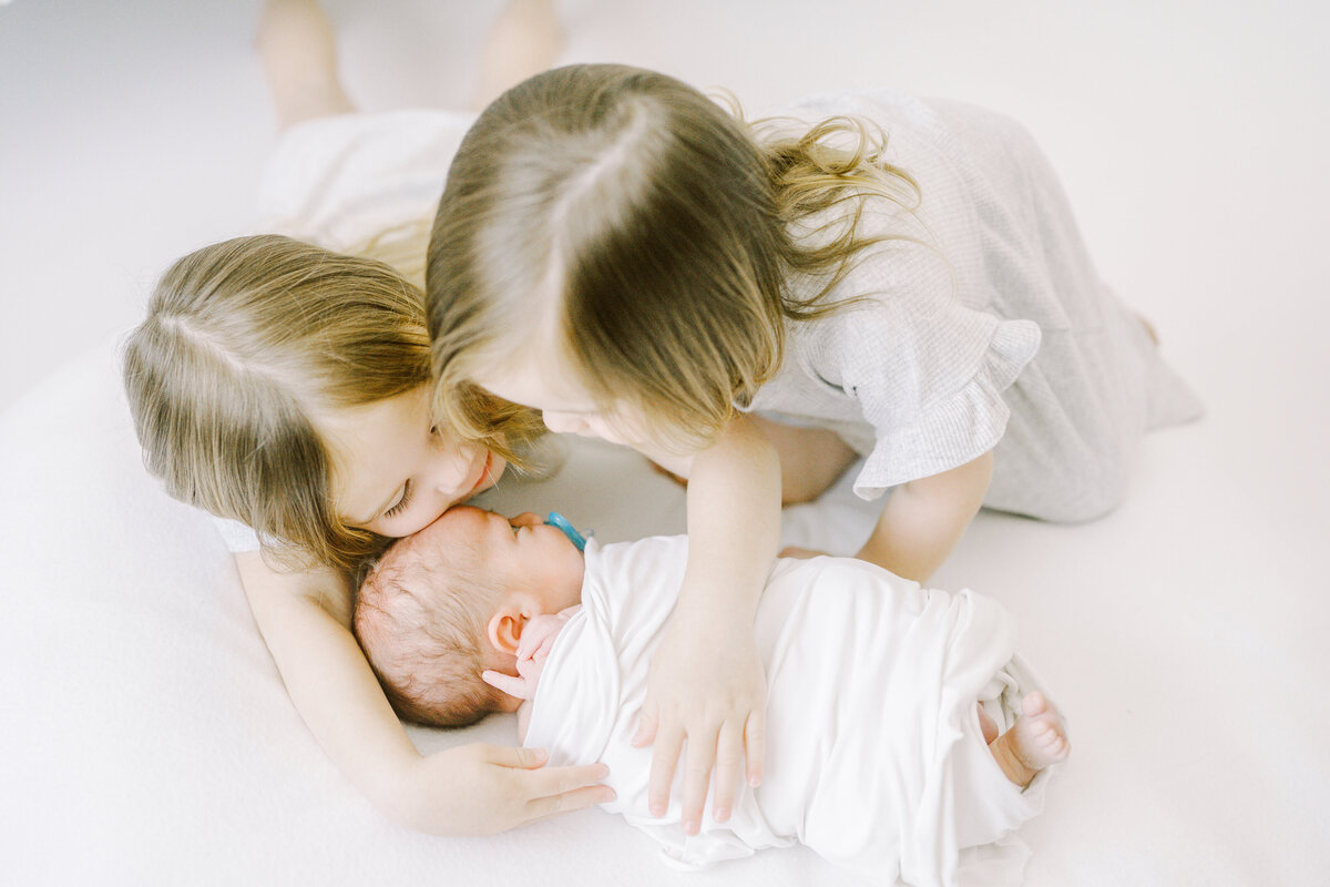 Older siblings with newborn brother in orange county newborn session