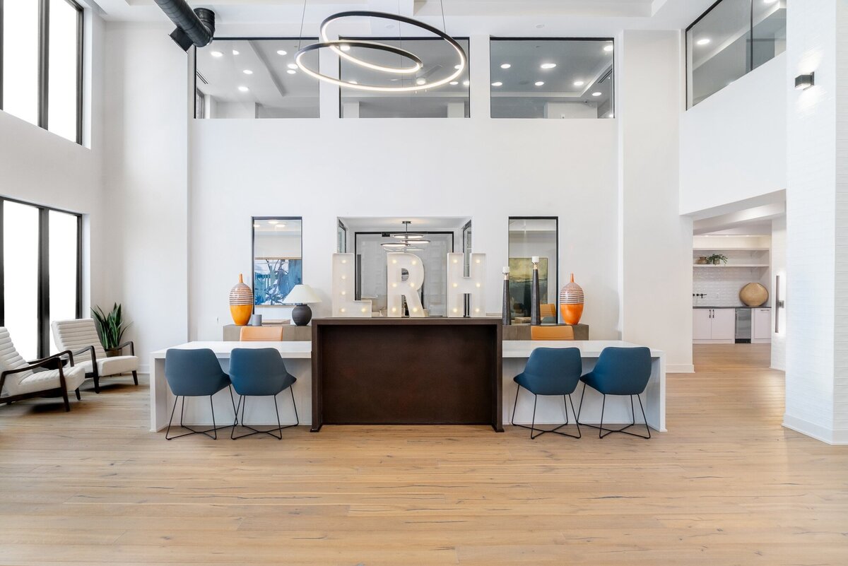 Blue chairs for apartment clubhouse designed by Gracious Home Interiors of Waxhaw NC