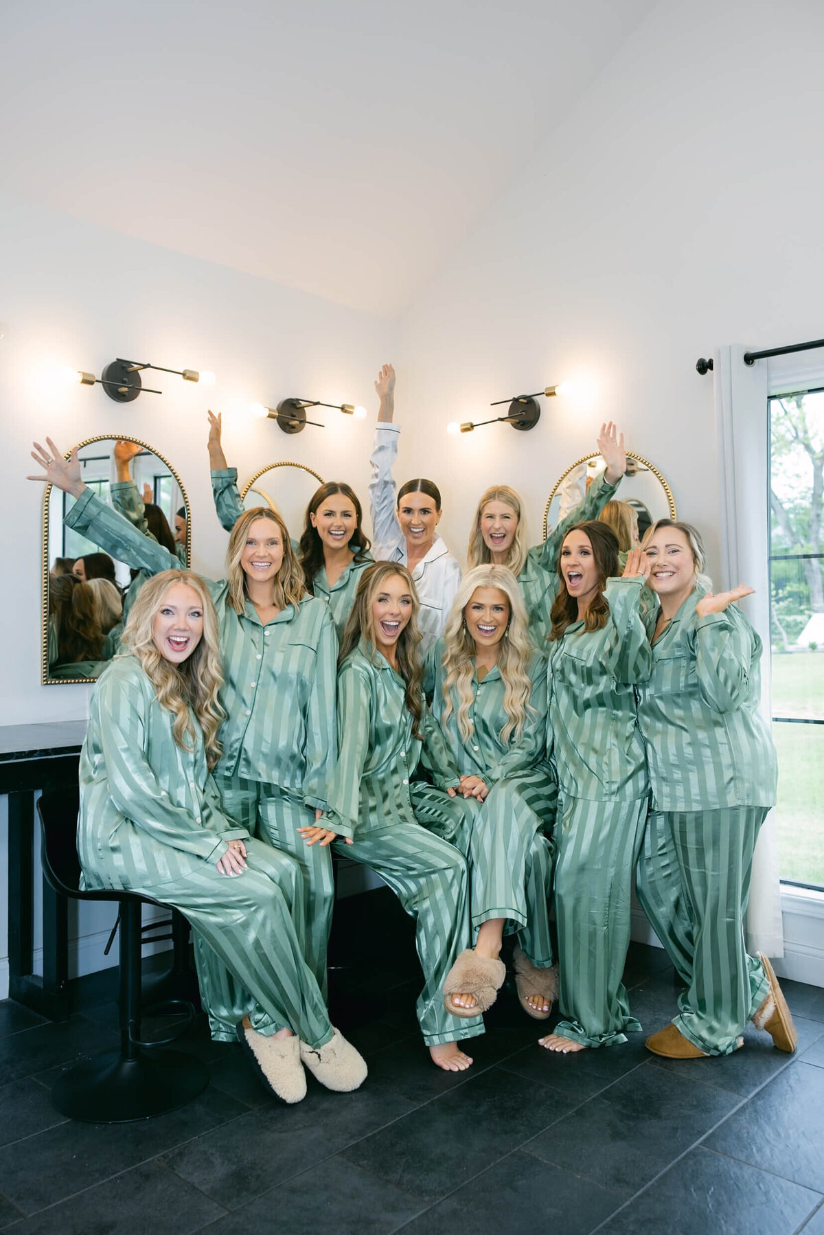 A wedding day photo of the bride and her bridesmaids in their pajamas as they get ready for the wedding
