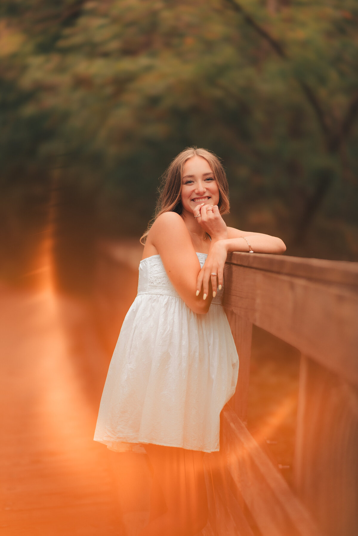 Artistic senior portrait with motion blur effect of girl running through meadow at sunset in Minnesota.
