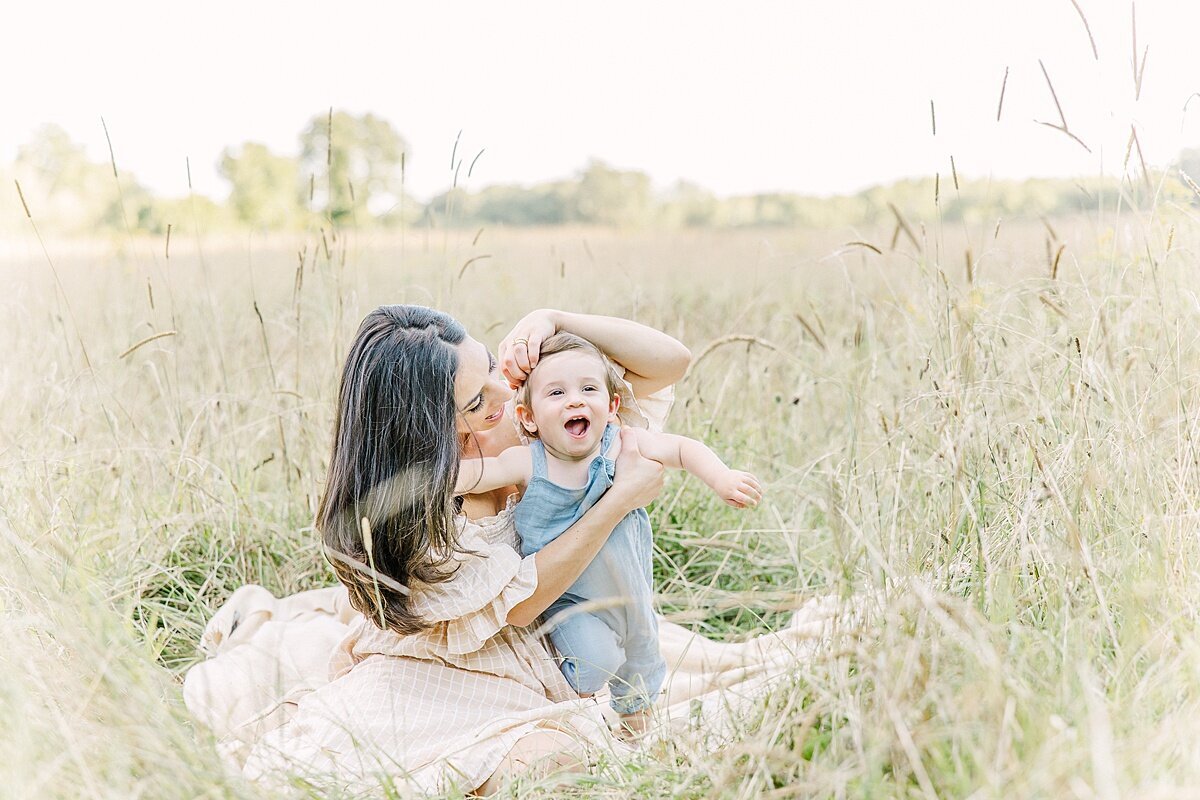 mom and son sit on blanket duirng summer  family photo session with Sara Sniderman Photography in Natick Massachusetts