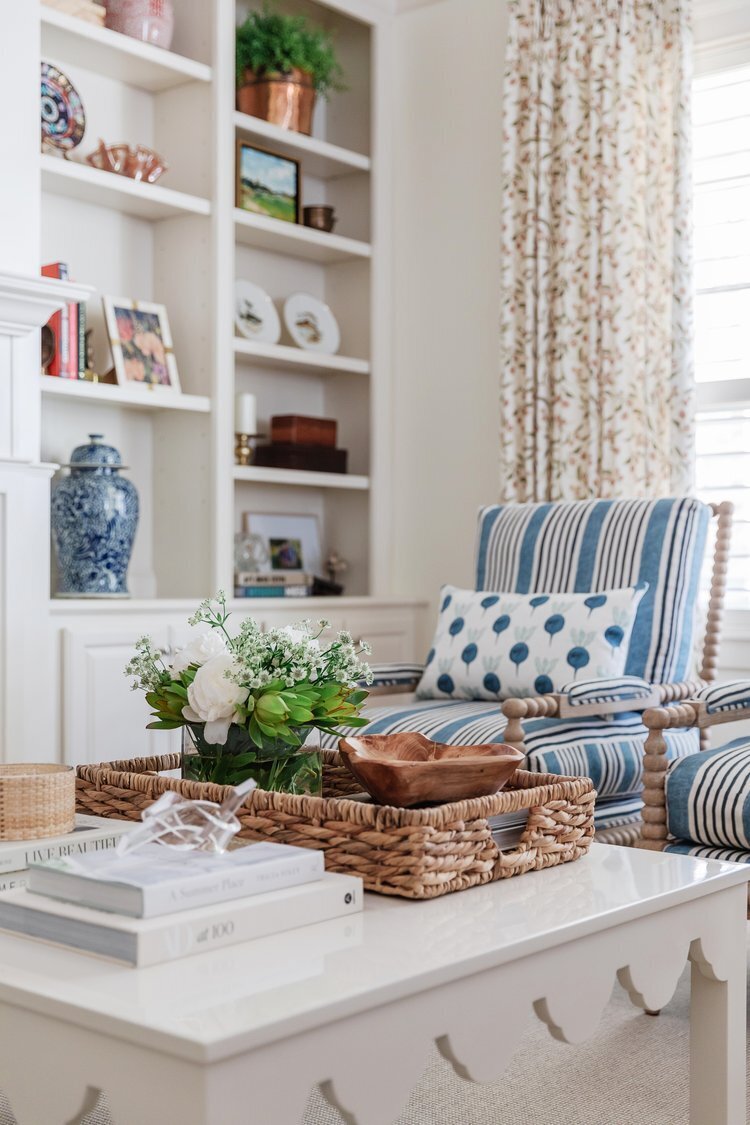 oyster creek studios oak forest remodel white coffee table with wicker basket and white shelving in living room