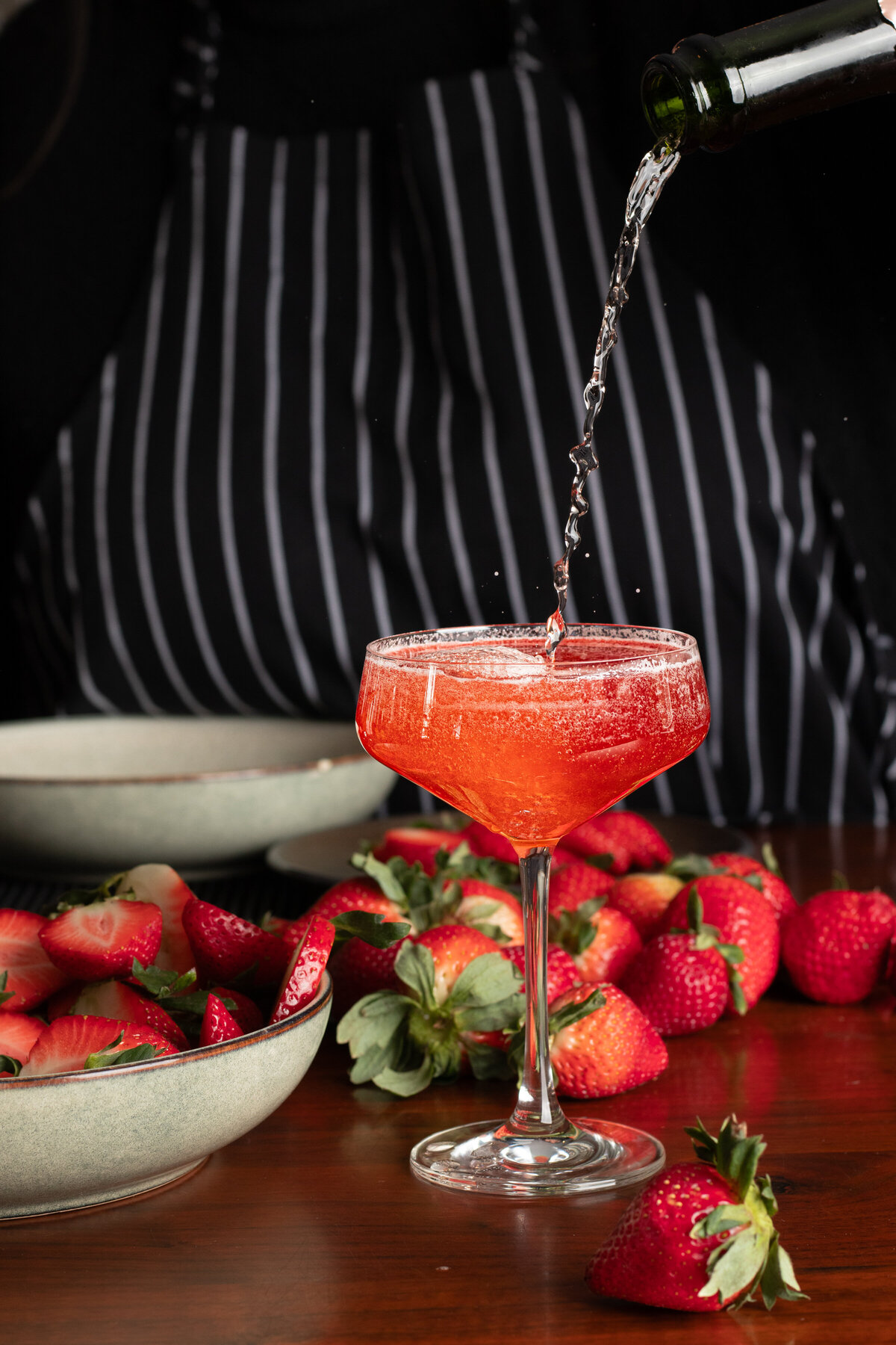a strawberry cocktail being poured