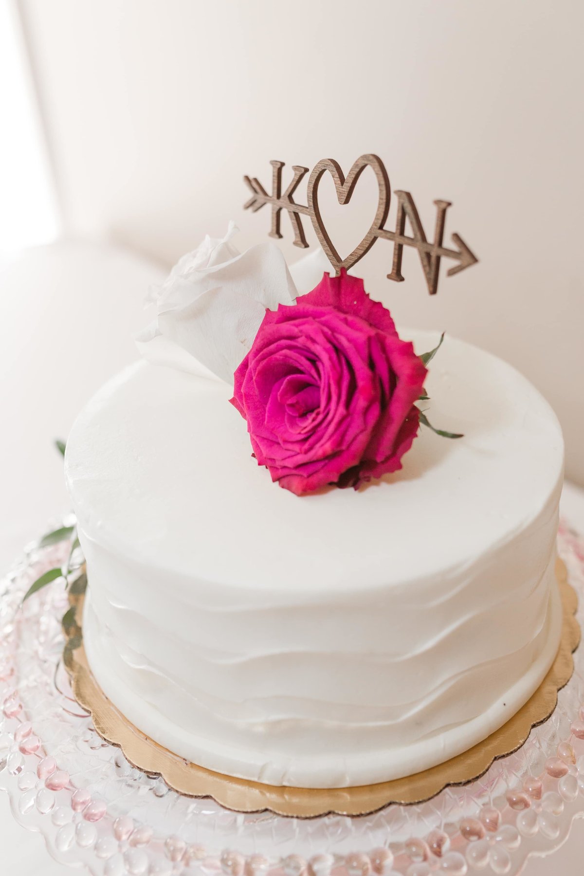 White wedding cake with roses and topper in Chicago, IL by Maira Ochoa Photography