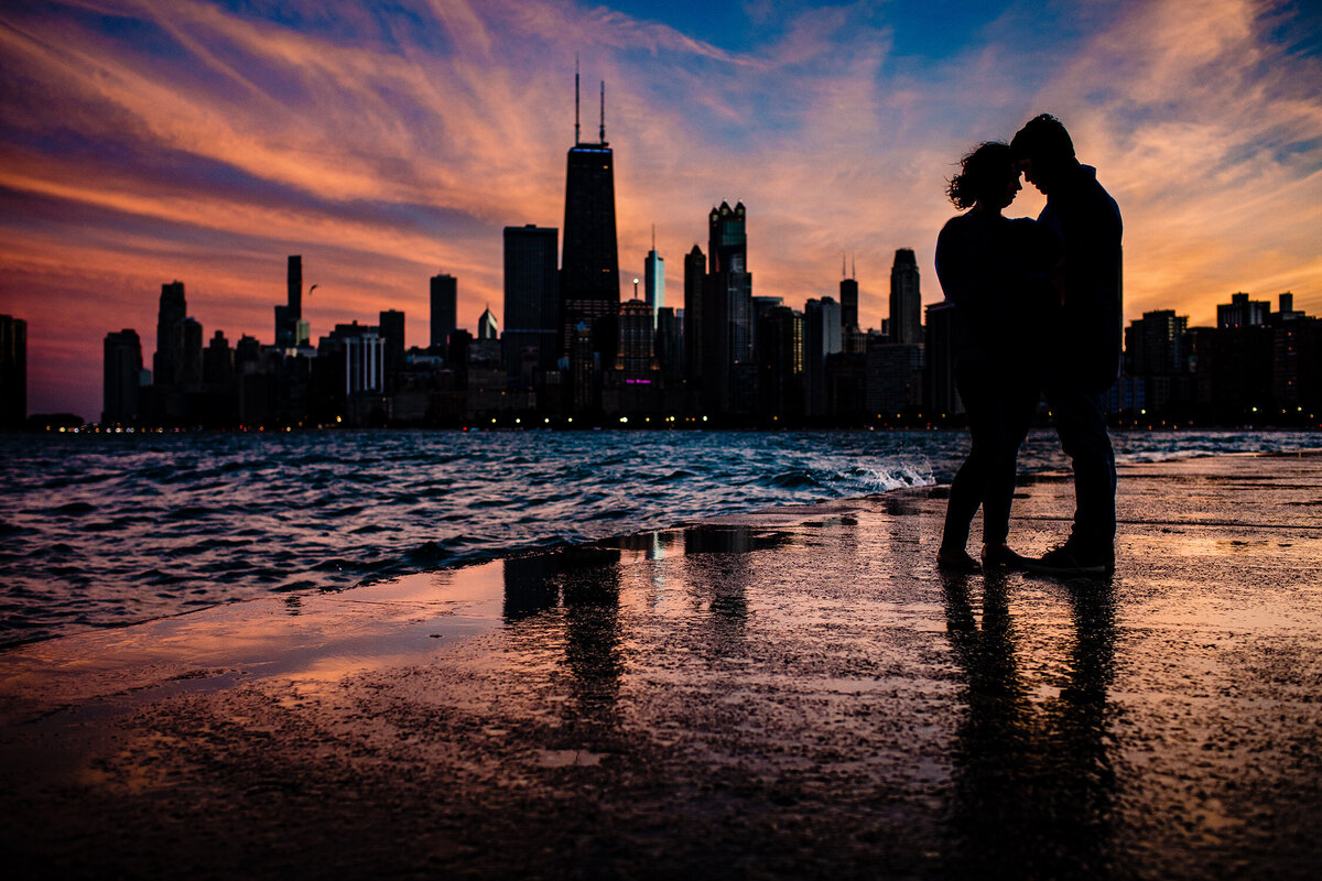 A couple share a hug during a North Avenue beach engagement session.