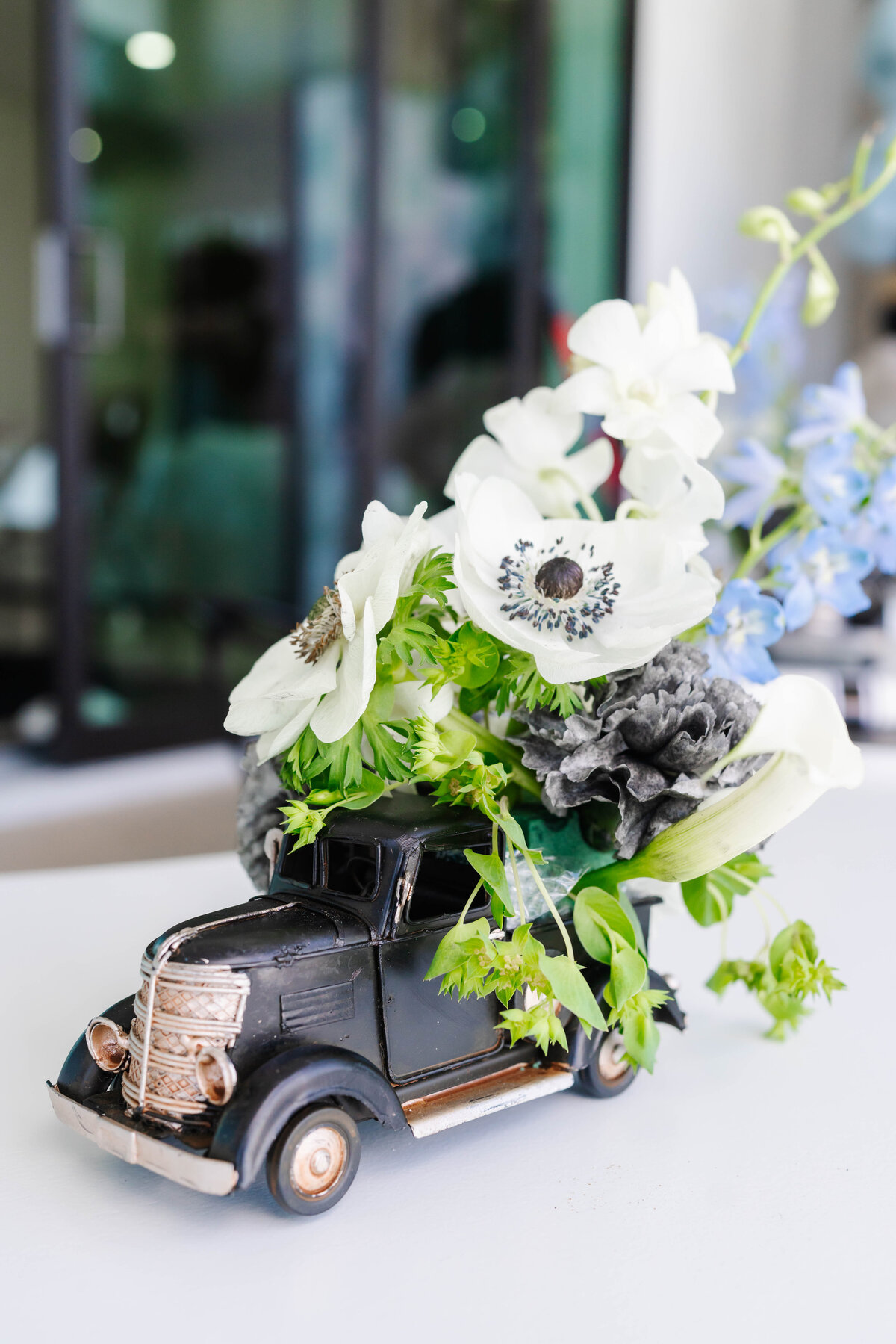 black vintage truck with white blue and green flowers 