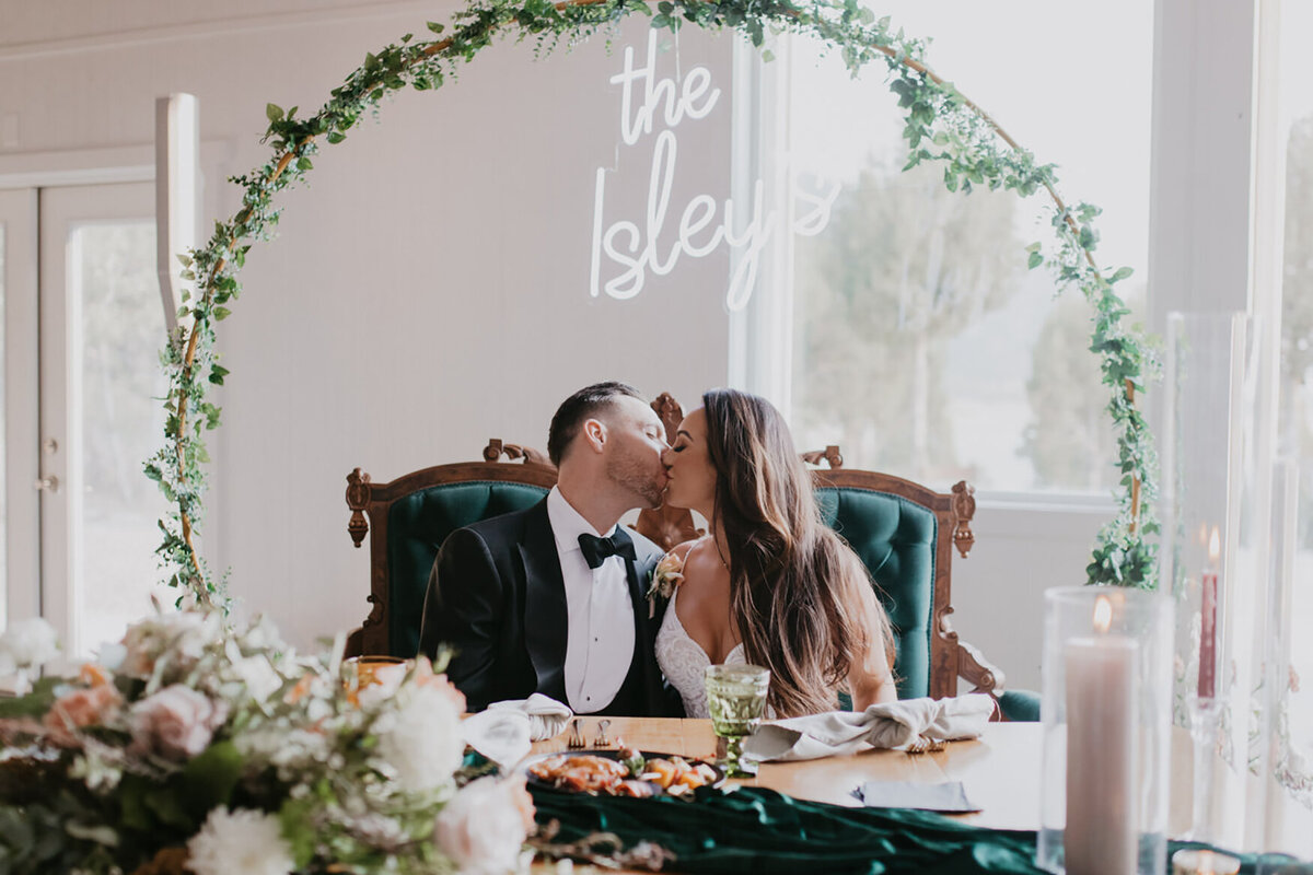 newlyweds kiss at table