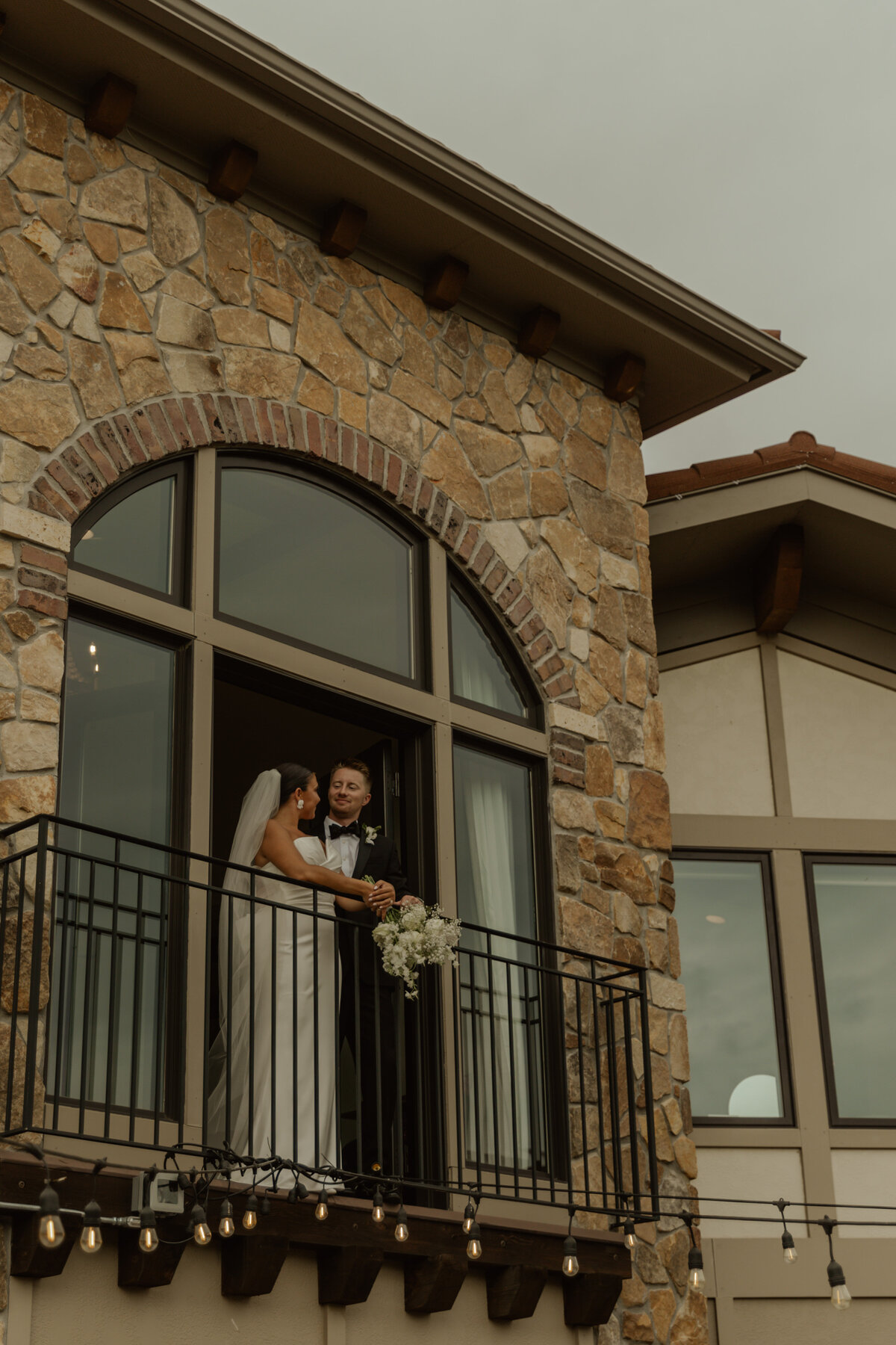 Mn Vineyard Wedding photos of couple on a balcony 