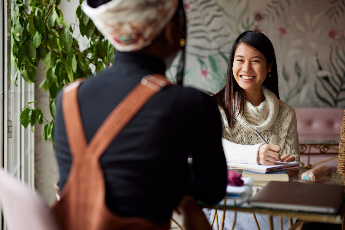 Smiling therapist in conversation during a friendly professional meeting.