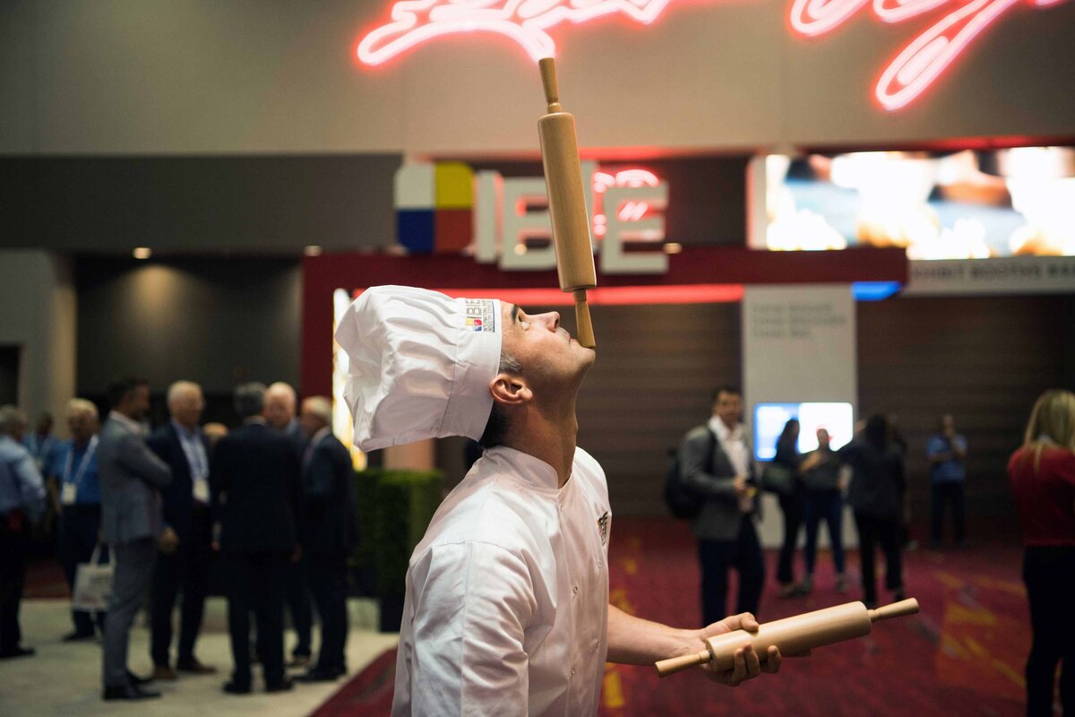 A Chef balances a rolling pin on his chin for entertainment at the Internation Bakers Expo in La Vegas