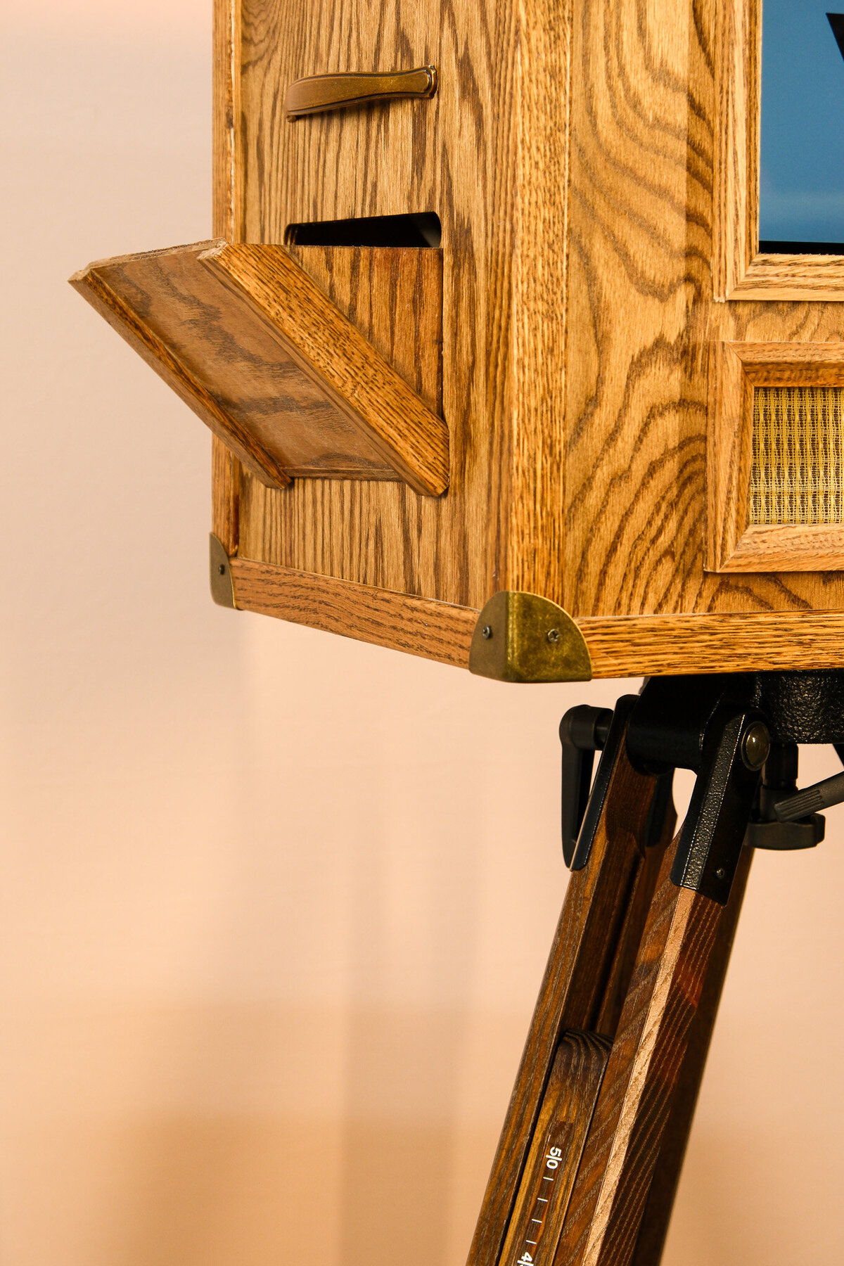 beautiful wooden photo booth taking photos to a bride with tatoos