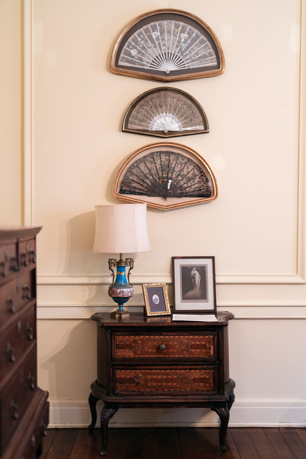 details in the yellow room at Oxmoor Farm including antique fans and armoire