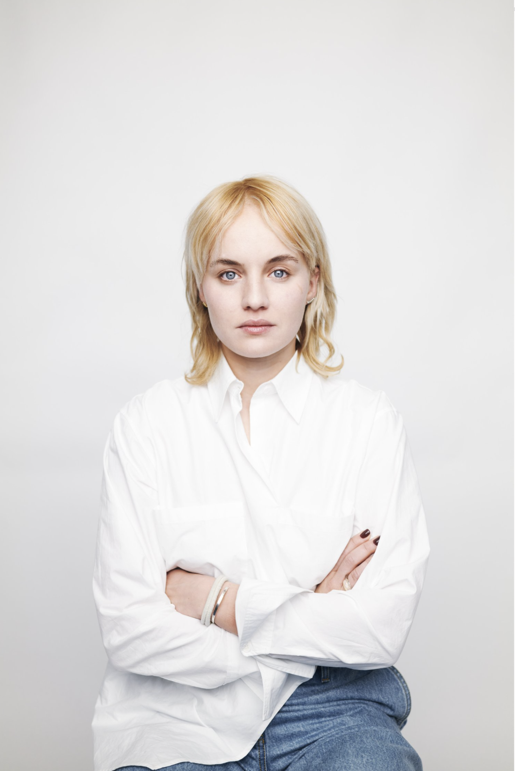 A dimly lit confrontation between characters, lit with chiaroscuro contrast.