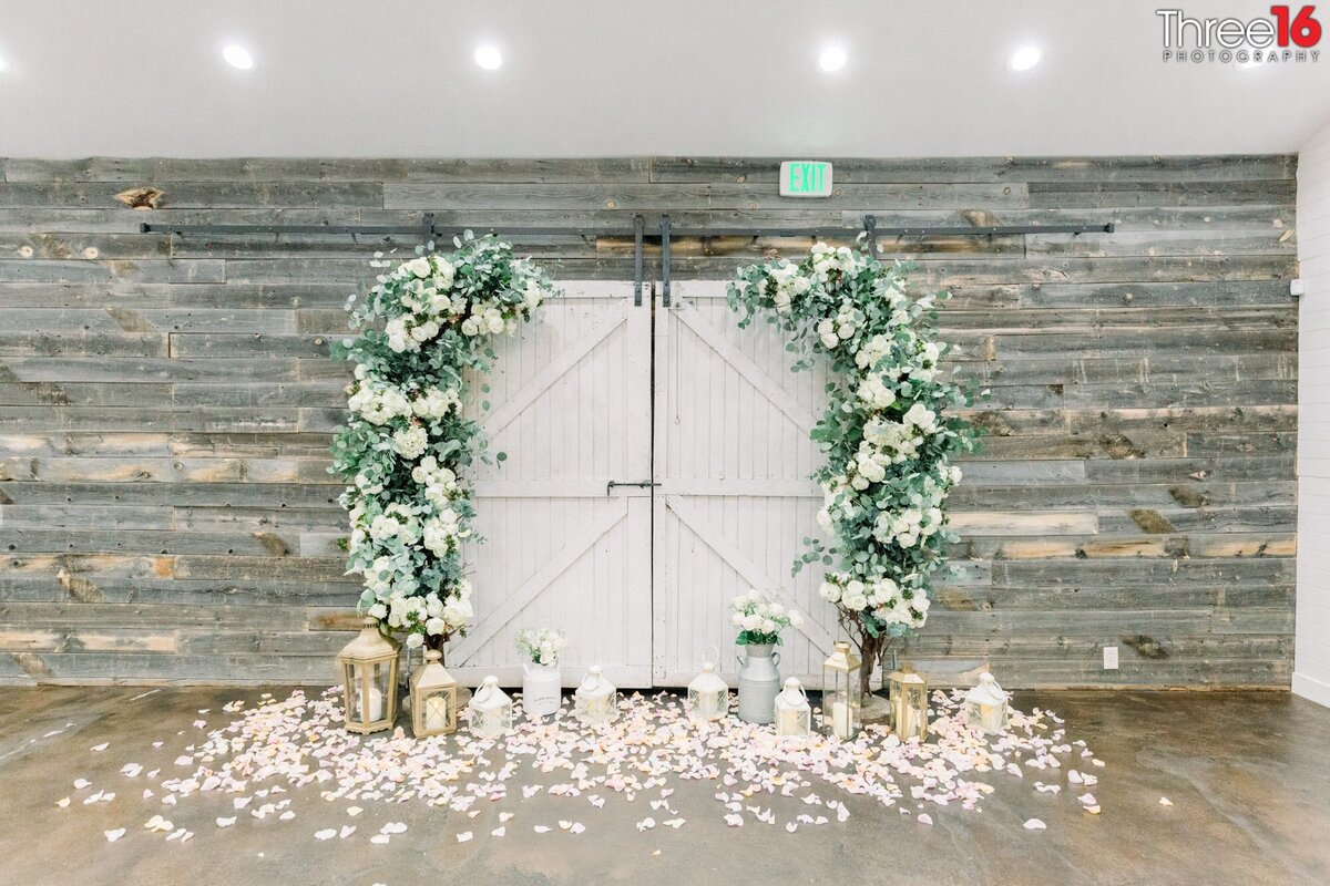 Beautifully decorated barn-style doors for wedding altar