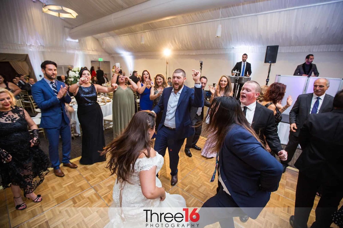 Bride dances with male guests