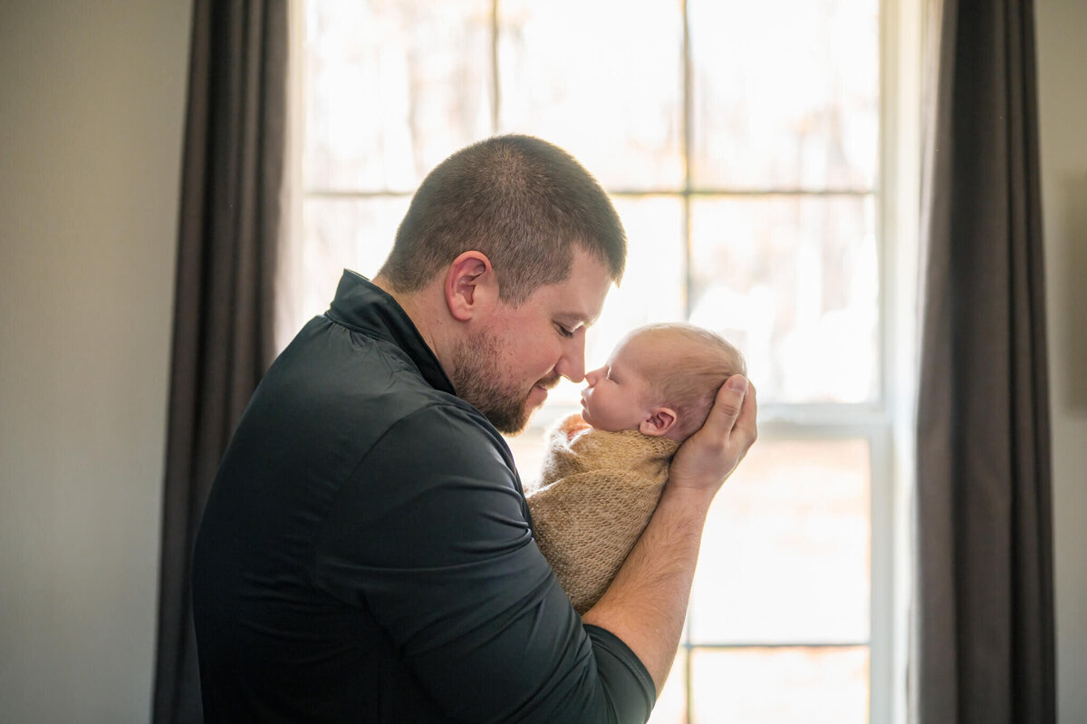 dad and newborn nose to nose