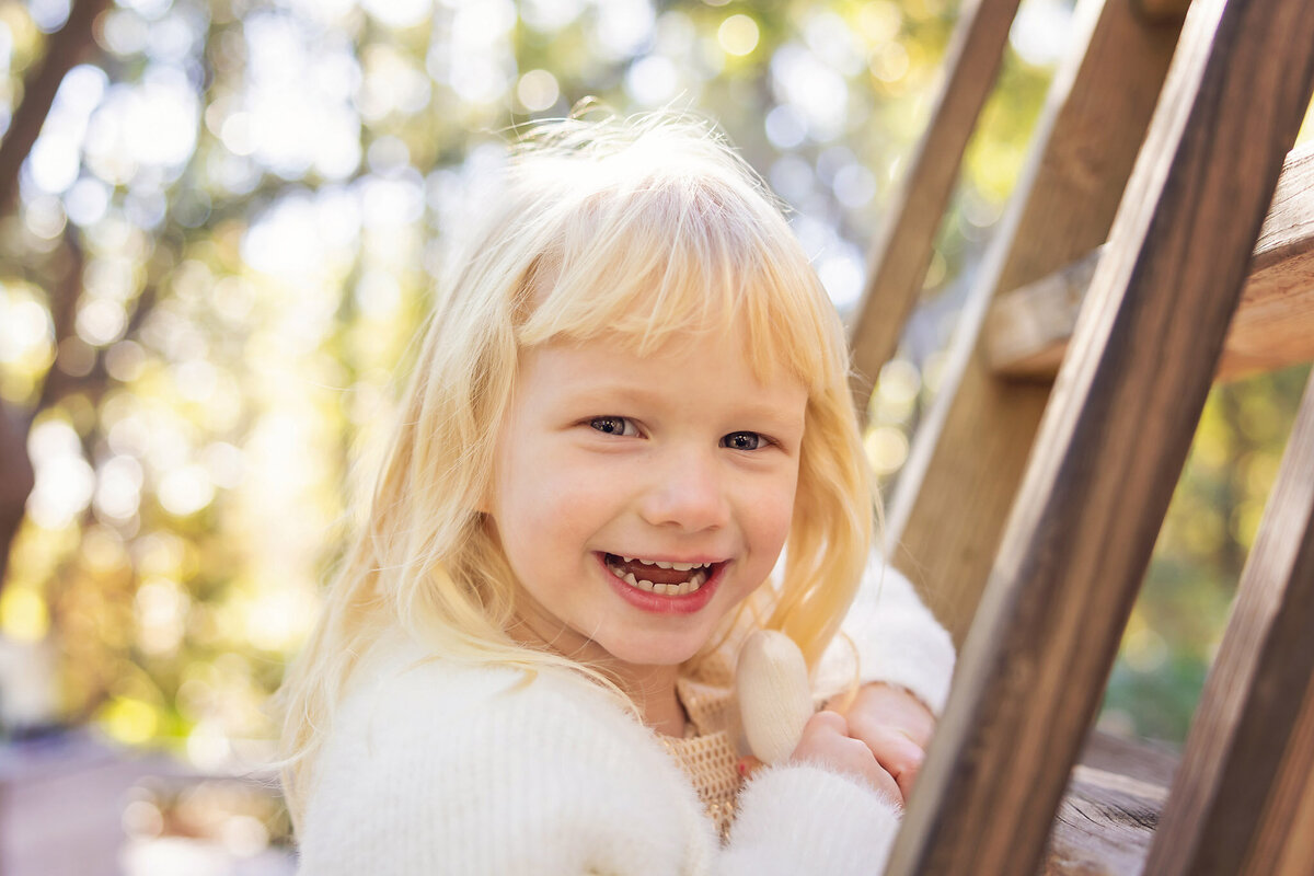toddler smiling at me at a playground in Sandestin Beach Resort, Florida.