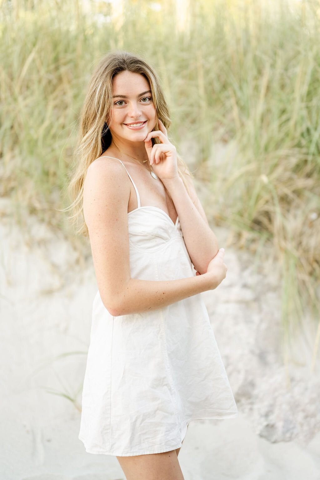 high school Senior photo in the dunes  by the beach