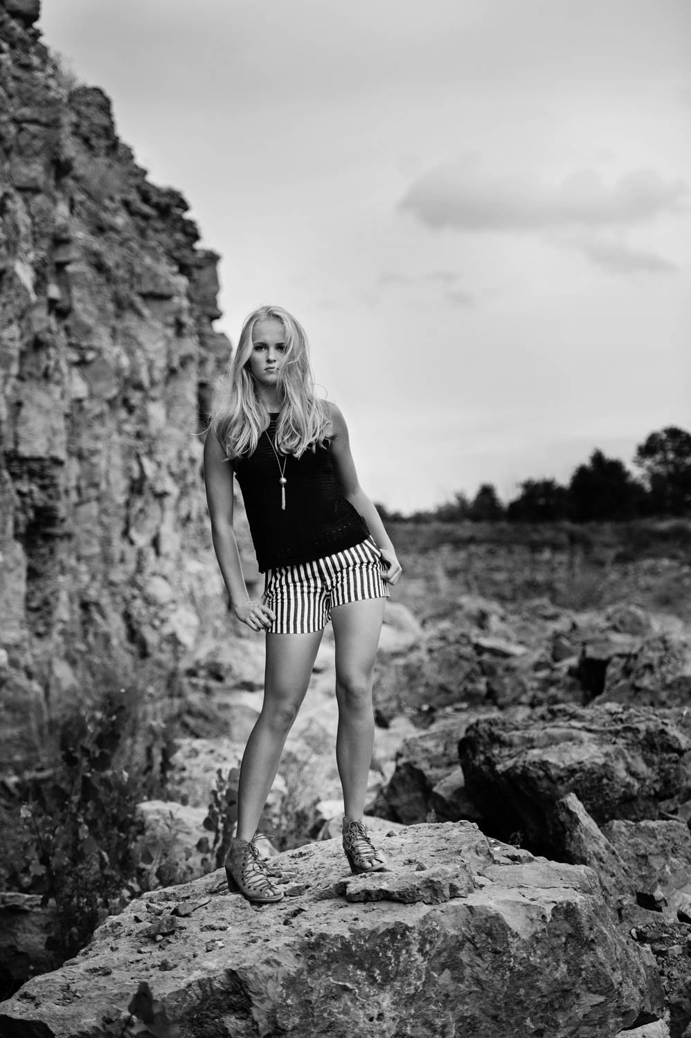 Chanhassen MN senior on rock with shorts in black and white