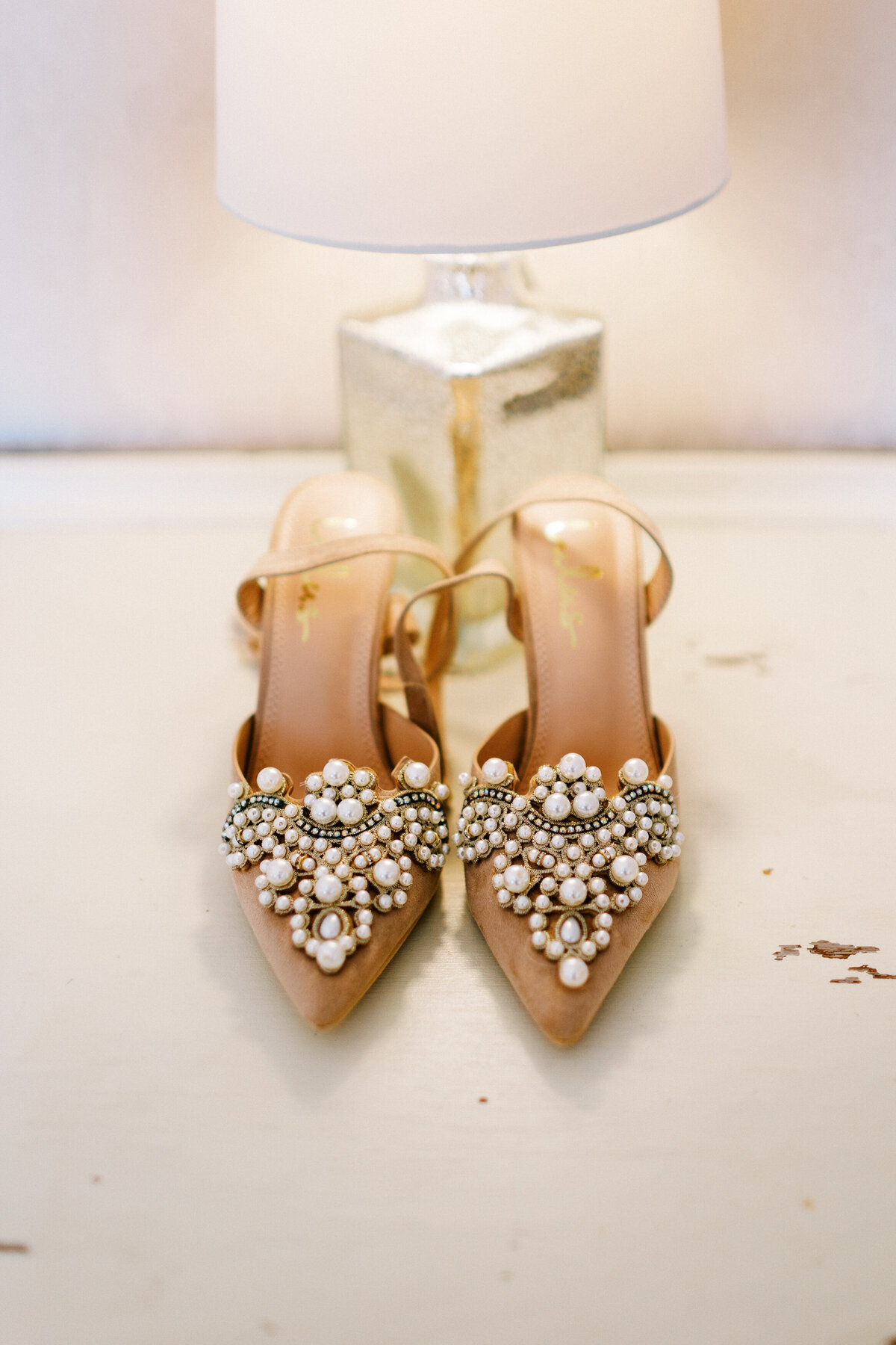 beautiful wedding shoes sitting under the lamp