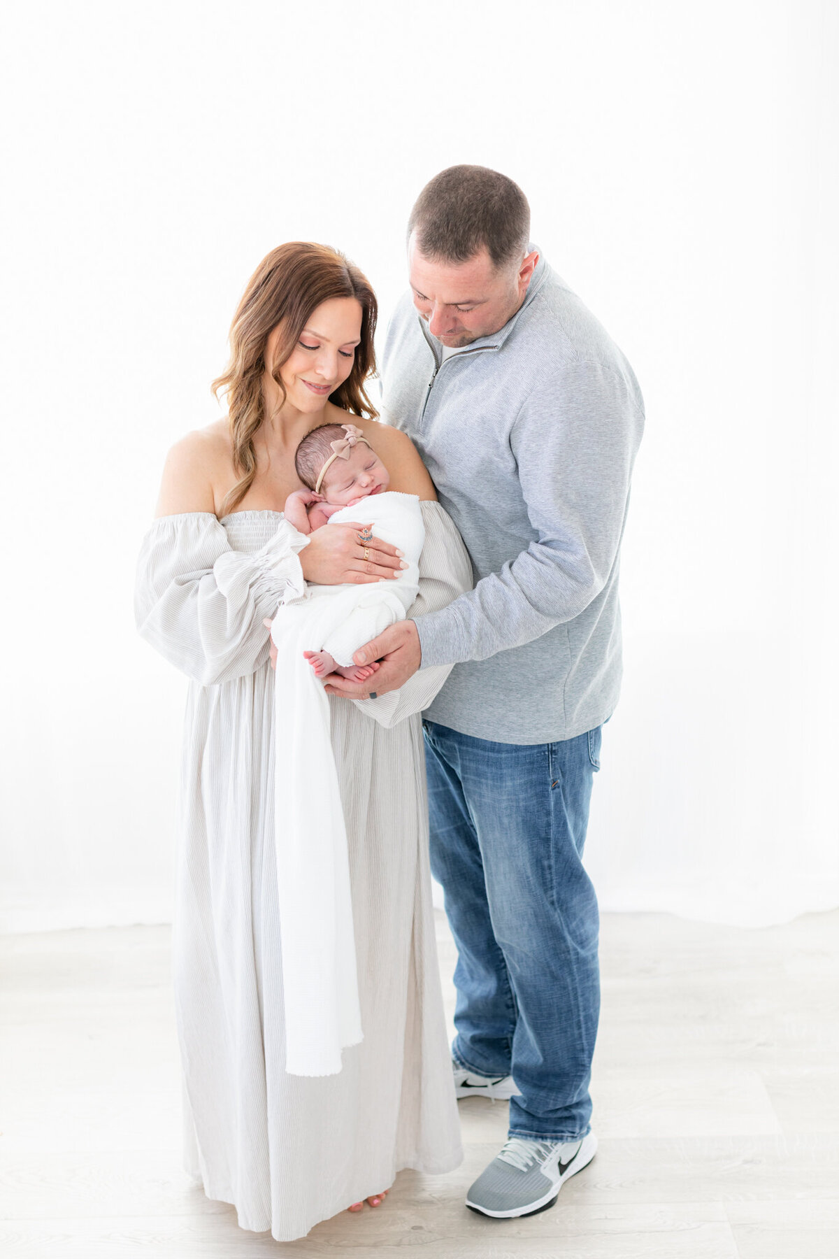family of three during studio newborn photoshoot in boston