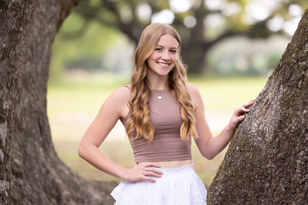 Senior portrait by the Avenue of the Oaks at Springhill College in Mobile, Alabama.