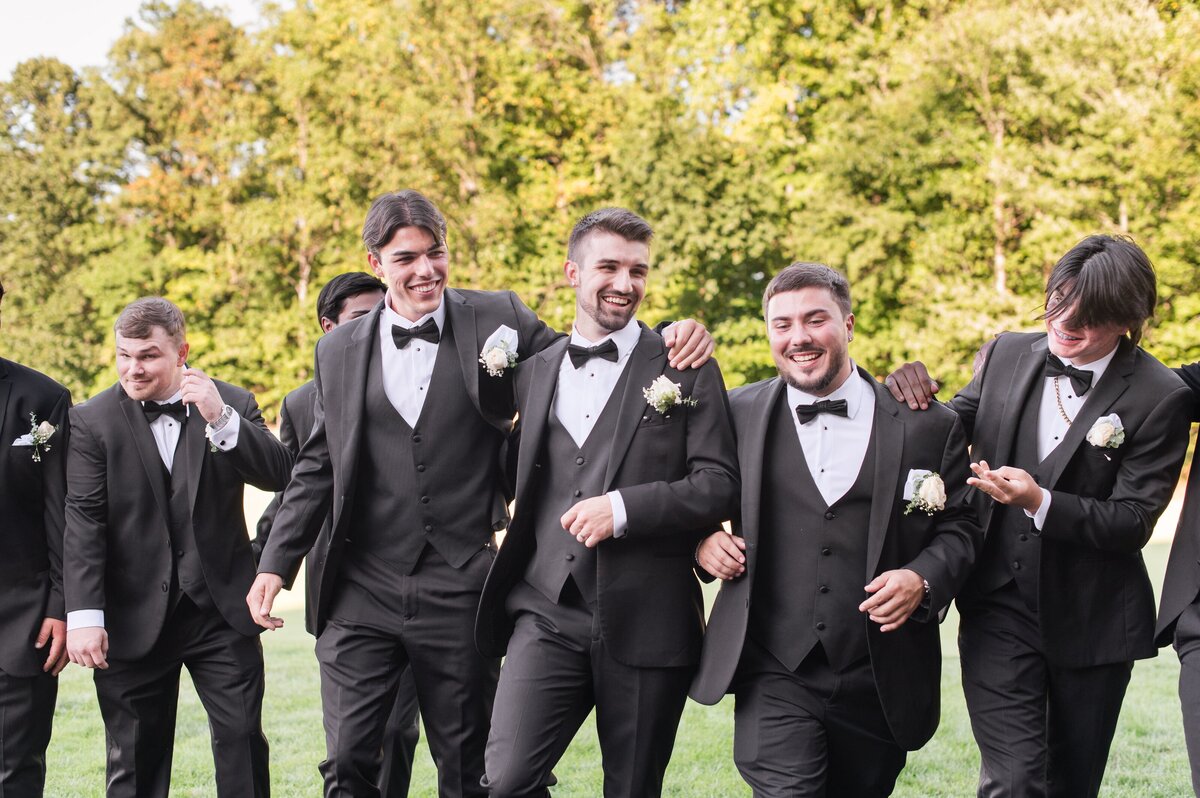 groomemen on golf course black tuxedos