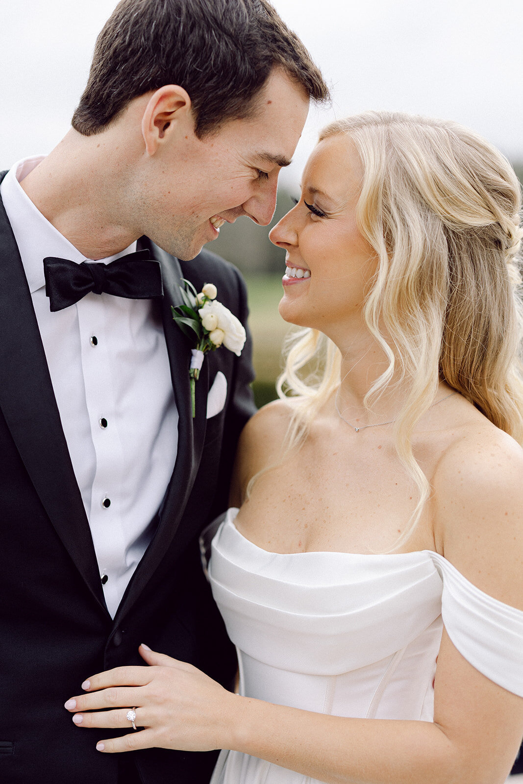 up close Bride and groom smiling at each other beside a fountain at a beautiful Columbus wedding venue shot by a philly wedding photographer