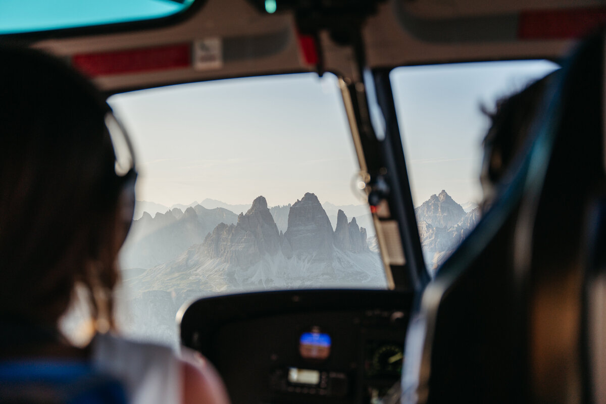 Helicopter flying over Dolomites peaks