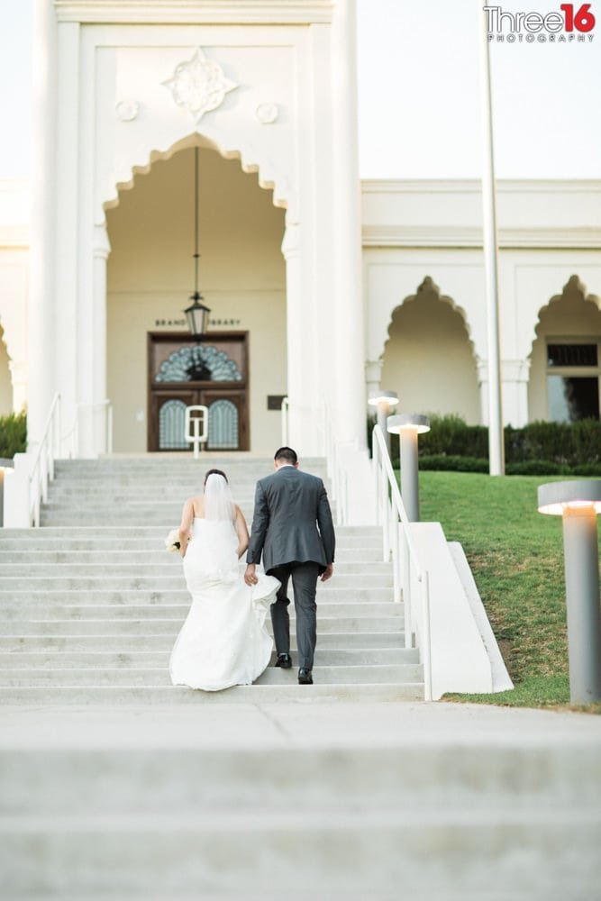 Bride and Groom walk up the steps to Brandview Ballroom
