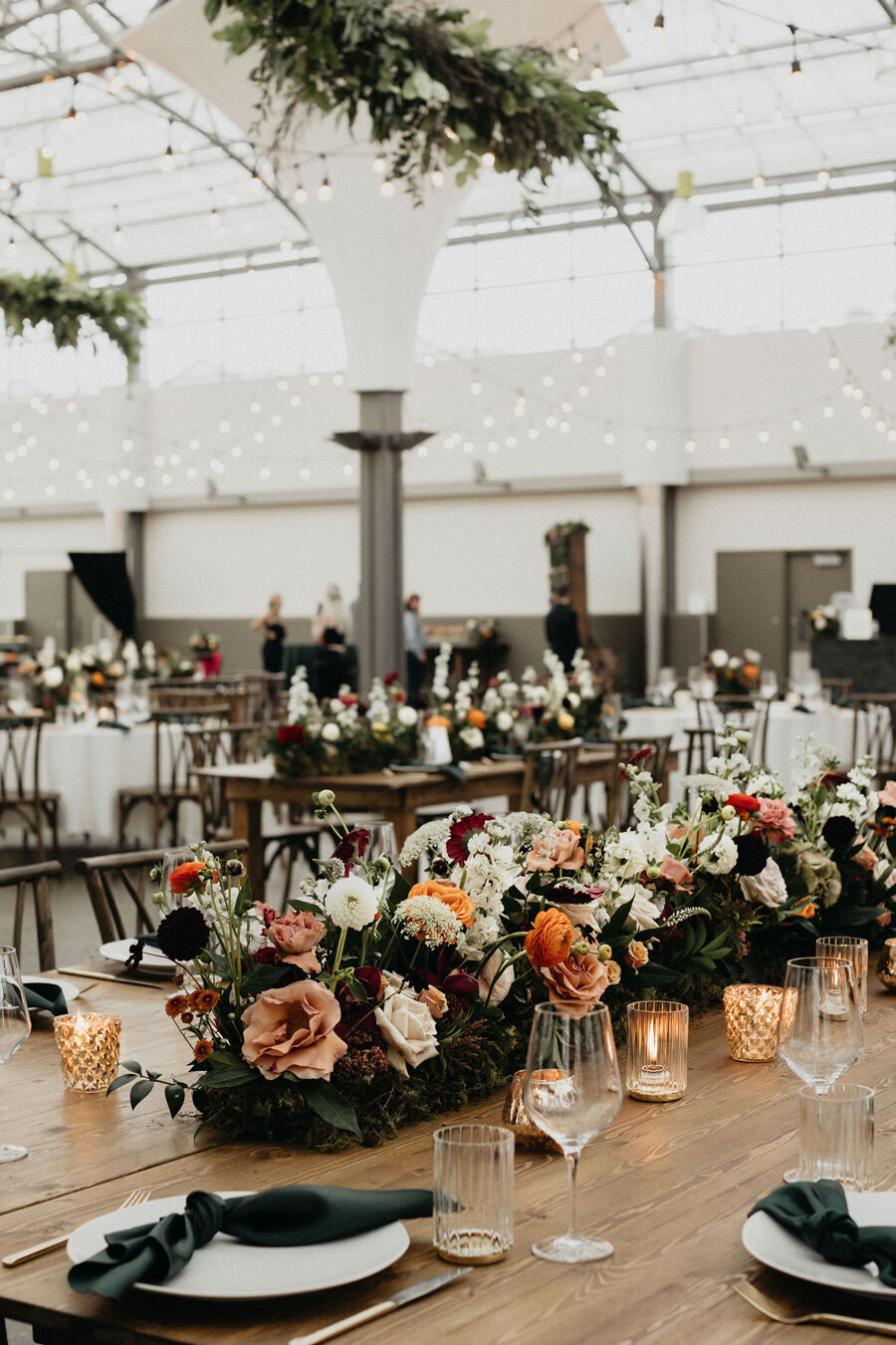 Wedding reception table decor with rich jewel tones and vintage vibes.