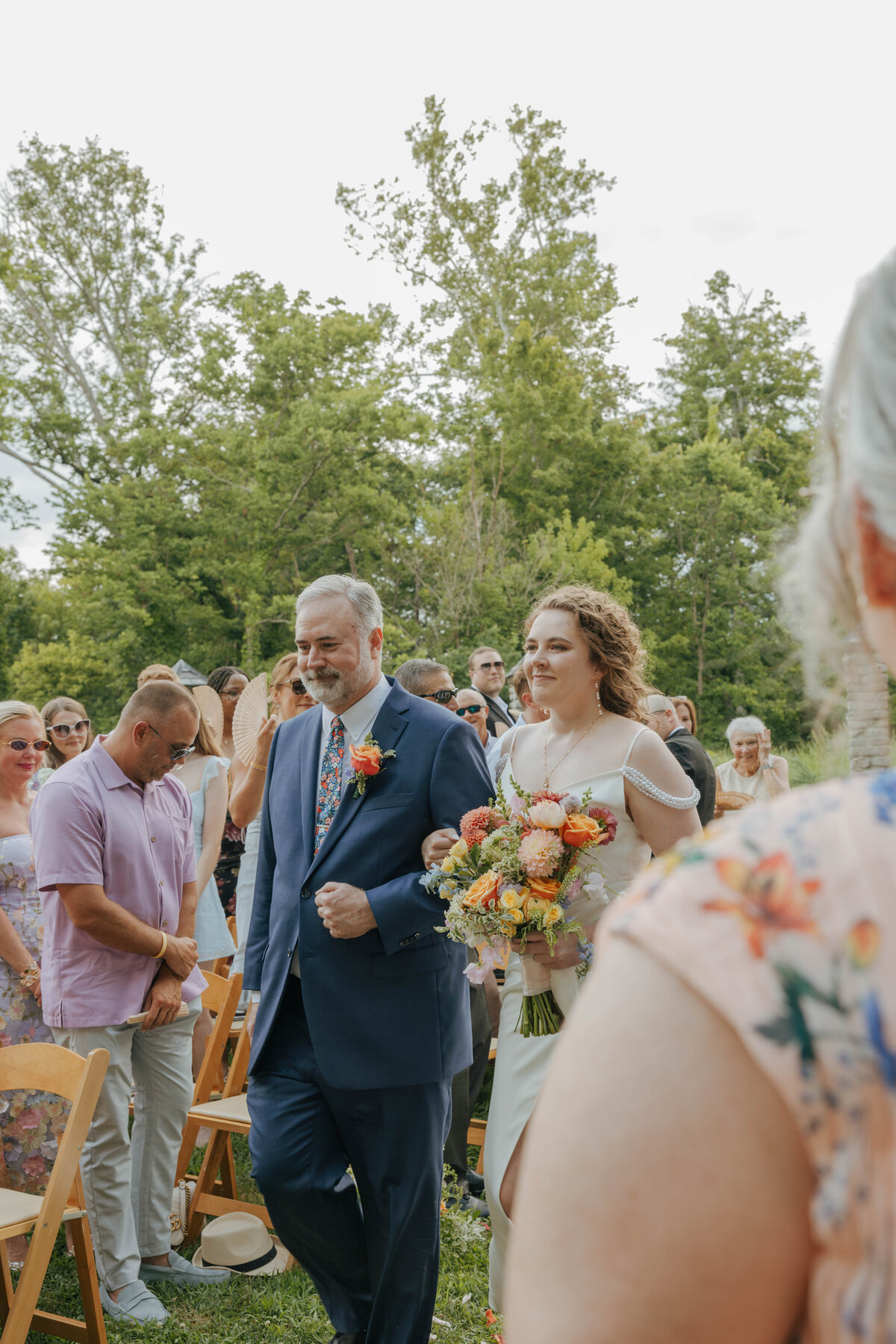 Bride being walked by her father at Groesbeck Estate outside 