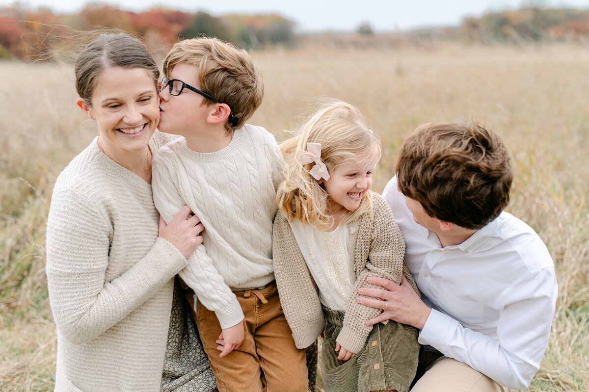 Milwaukee family photographer capturing a family in a field in Wisconsin